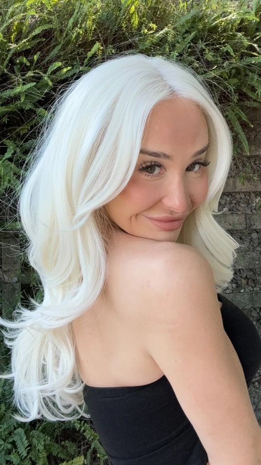 A model showcases a high-quality synthetic lace front wig with a natural hairline in a wig photo shoot