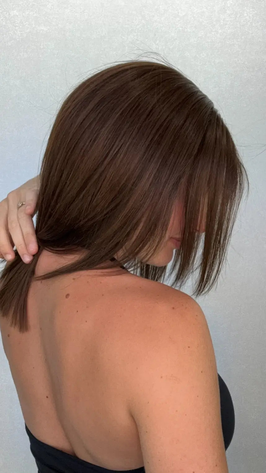 A side close-up of the 12-inch Lightest Density APRIL wig, showing the delicate warm-toned highlights