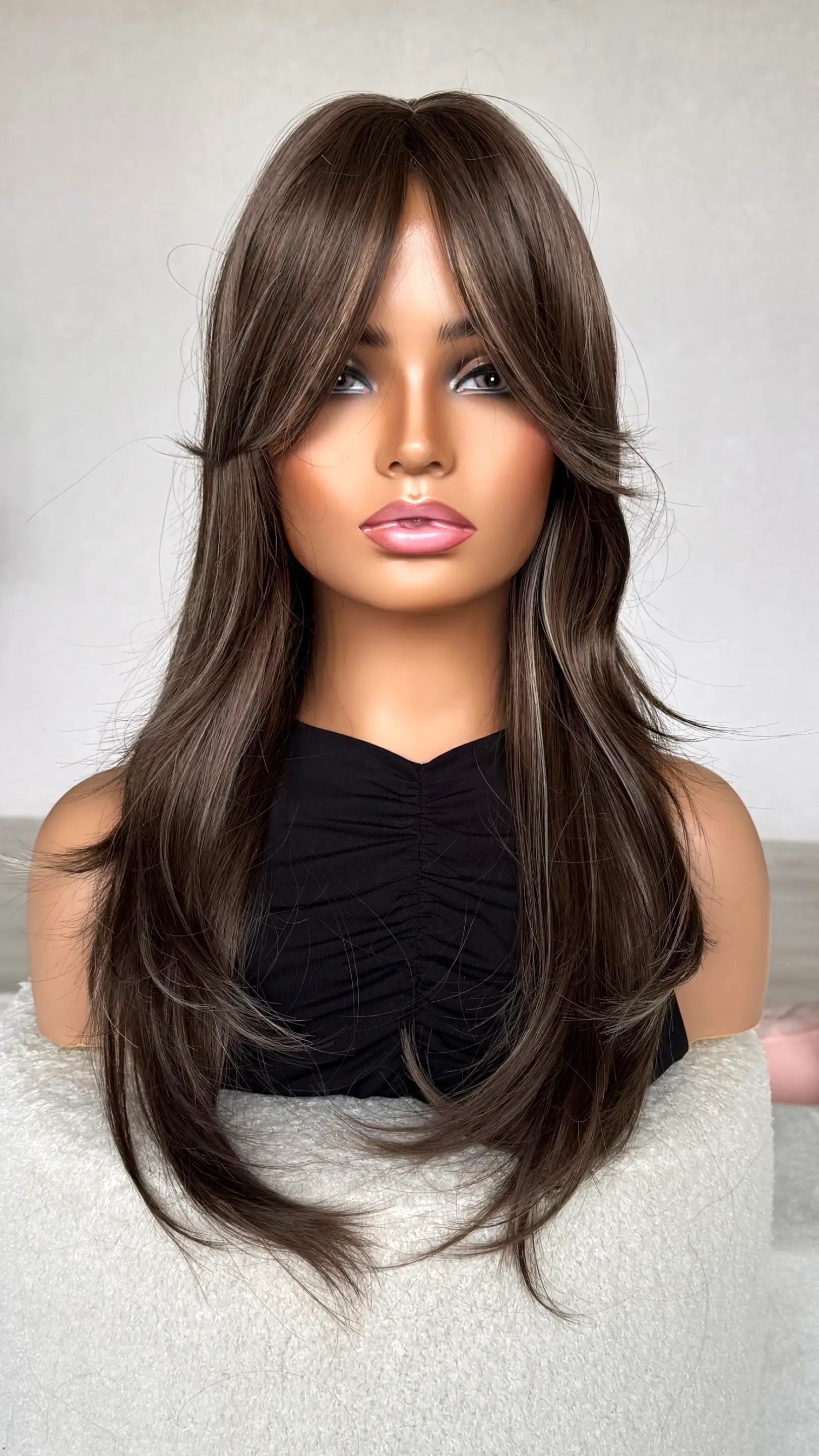 ash brunette hair, curtain bangs, front on, hair brushed more sleek.