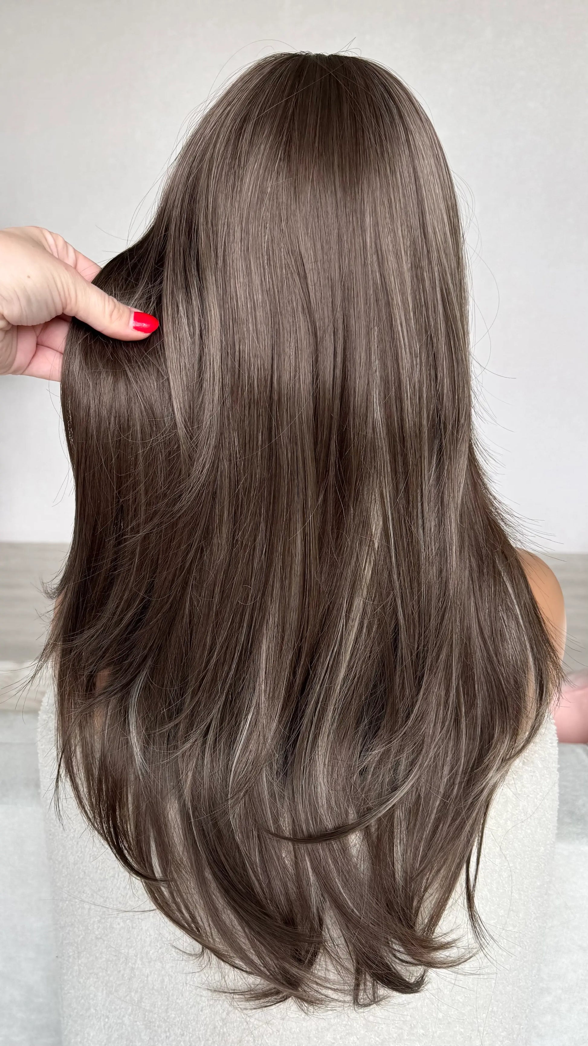 back view, showing ash brown hair colour with highlights.