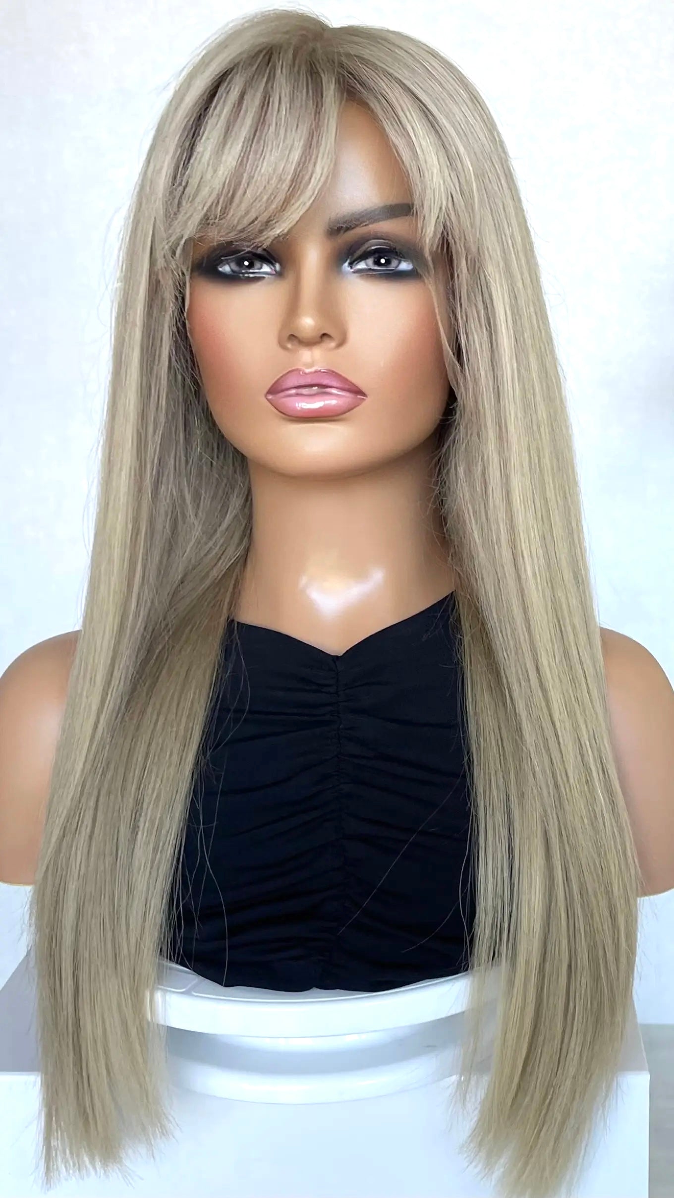 A close-up of the 24-inch CHARLI wig, highlighting its soft pearly ash blonde hue and delicate shine