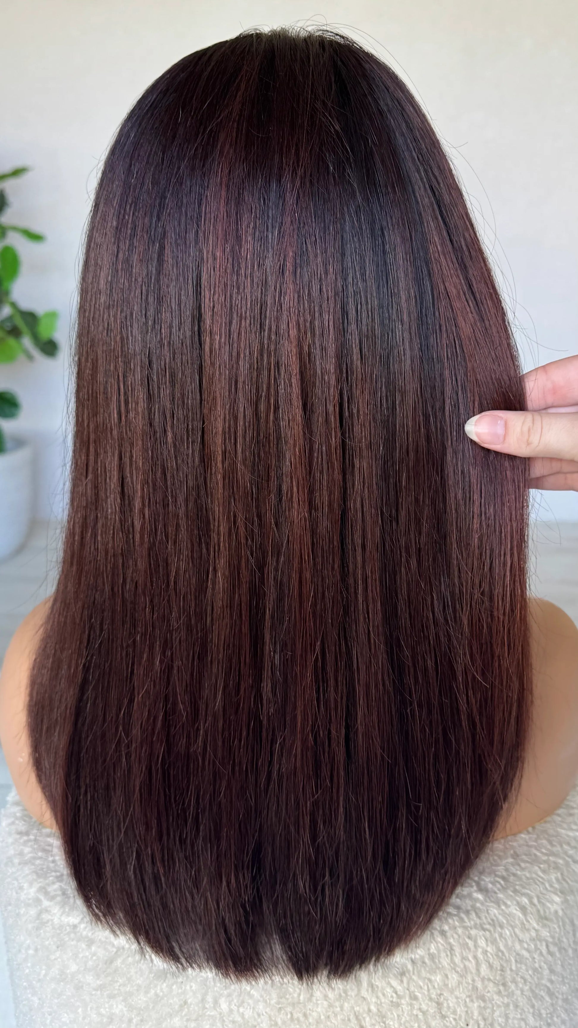 dark brown hair with red highlights from the back.
