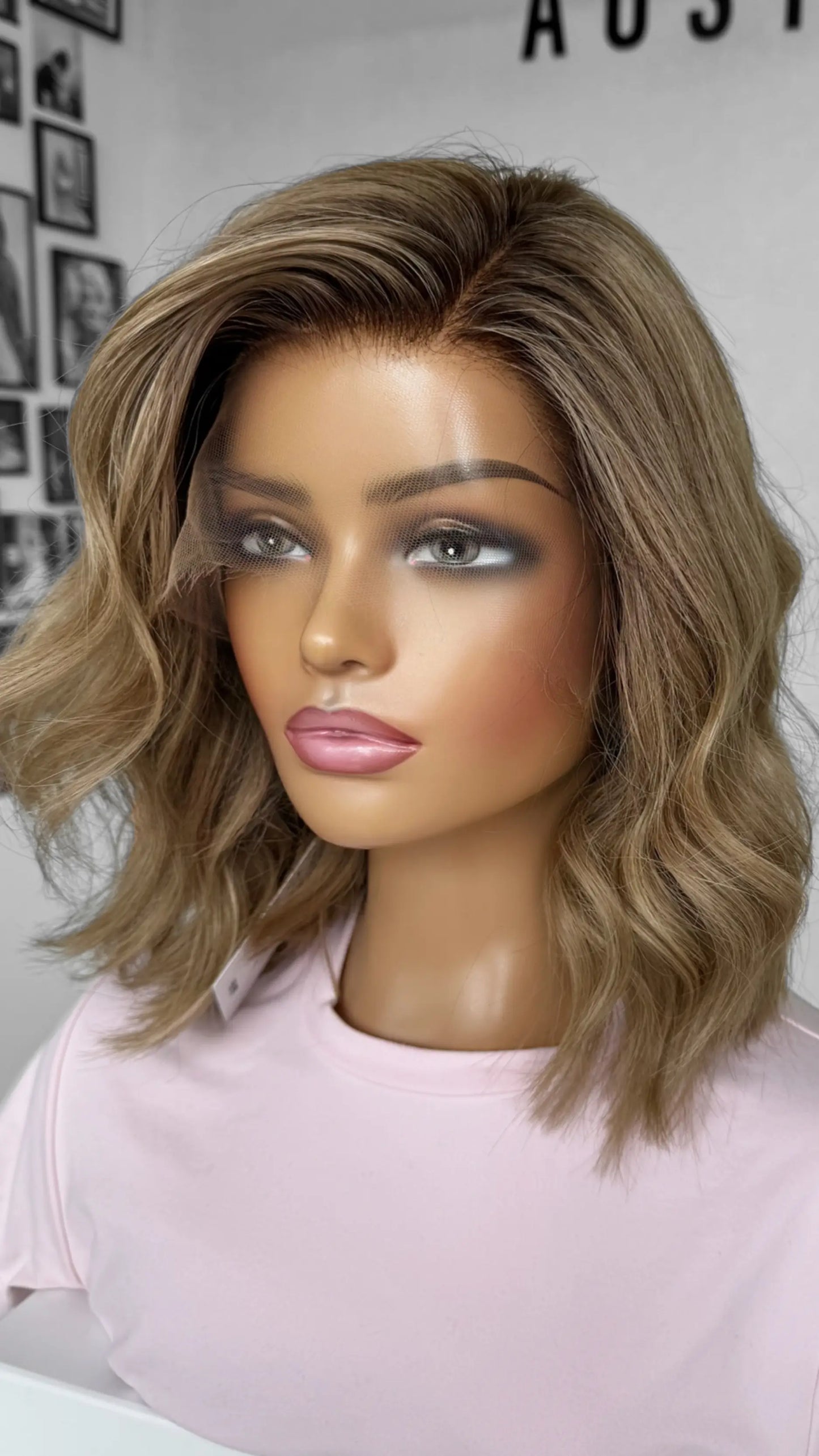 Side view of the JUDY wig, featuring warm blonde tones with delicate highlights, styled in soft layers for volume and dimension