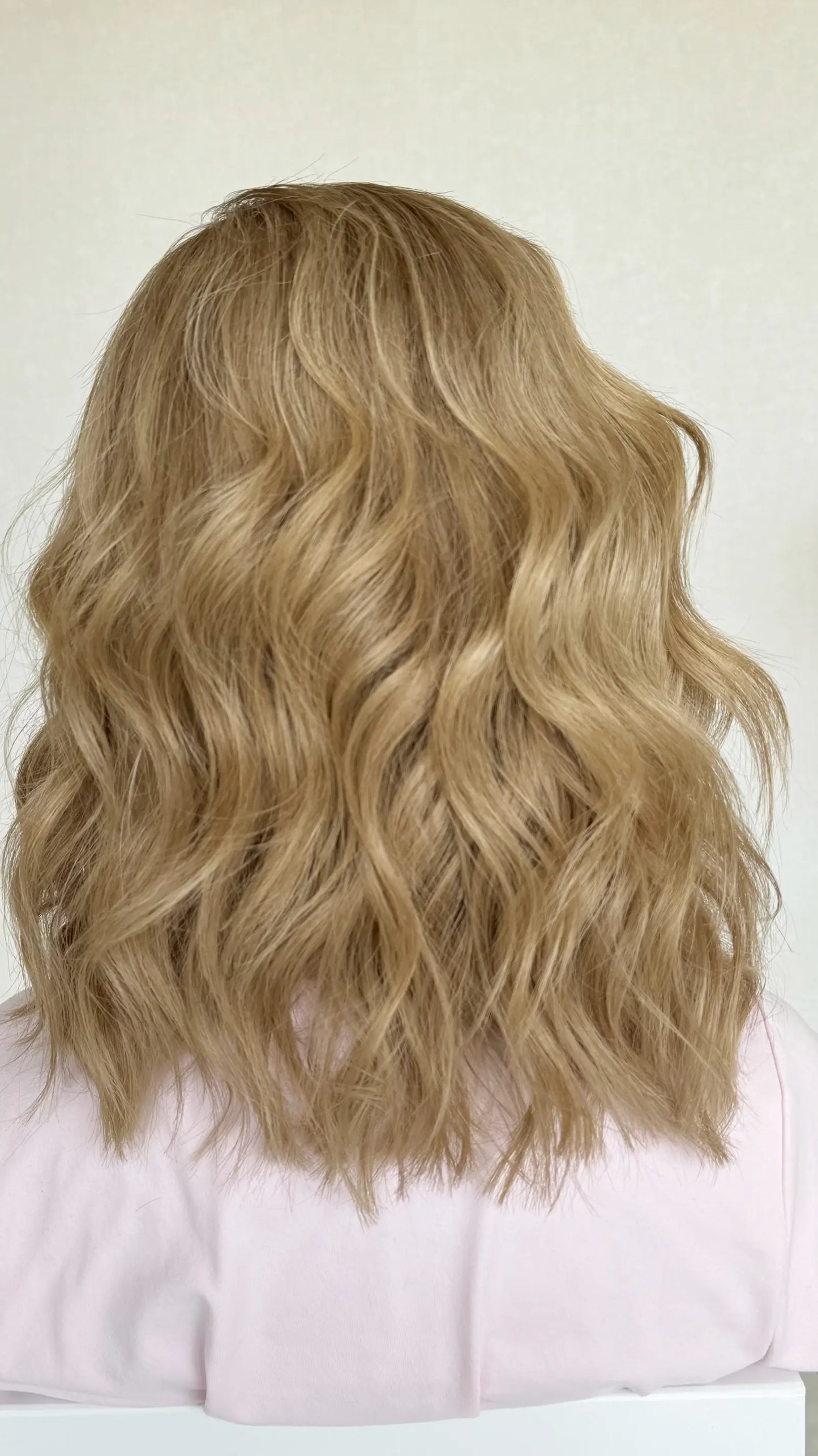 Back shot of the JUDY wig, showcasing its warm blonde base with subtle highlights and a seamless lace front for a natural loo