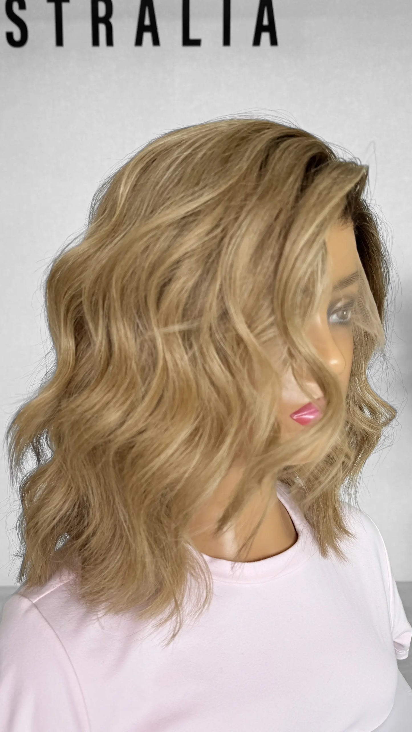 Another side view of the JUDY wig, featuring warm blonde tones with delicate highlights