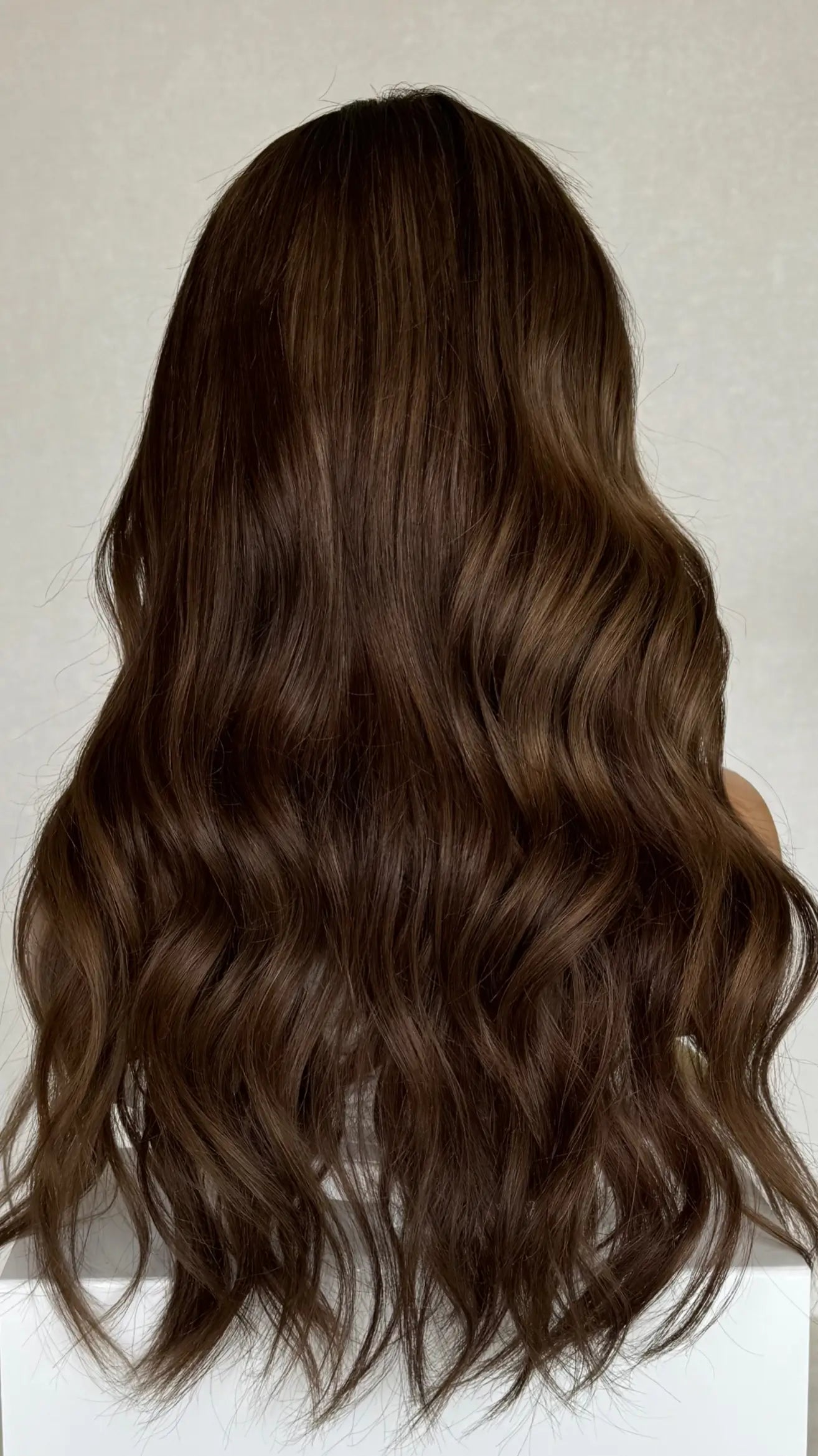 Back view of the Lexi wig, showcasing its deep chocolate brunette shade with smooth, flowing layers for volume and movement