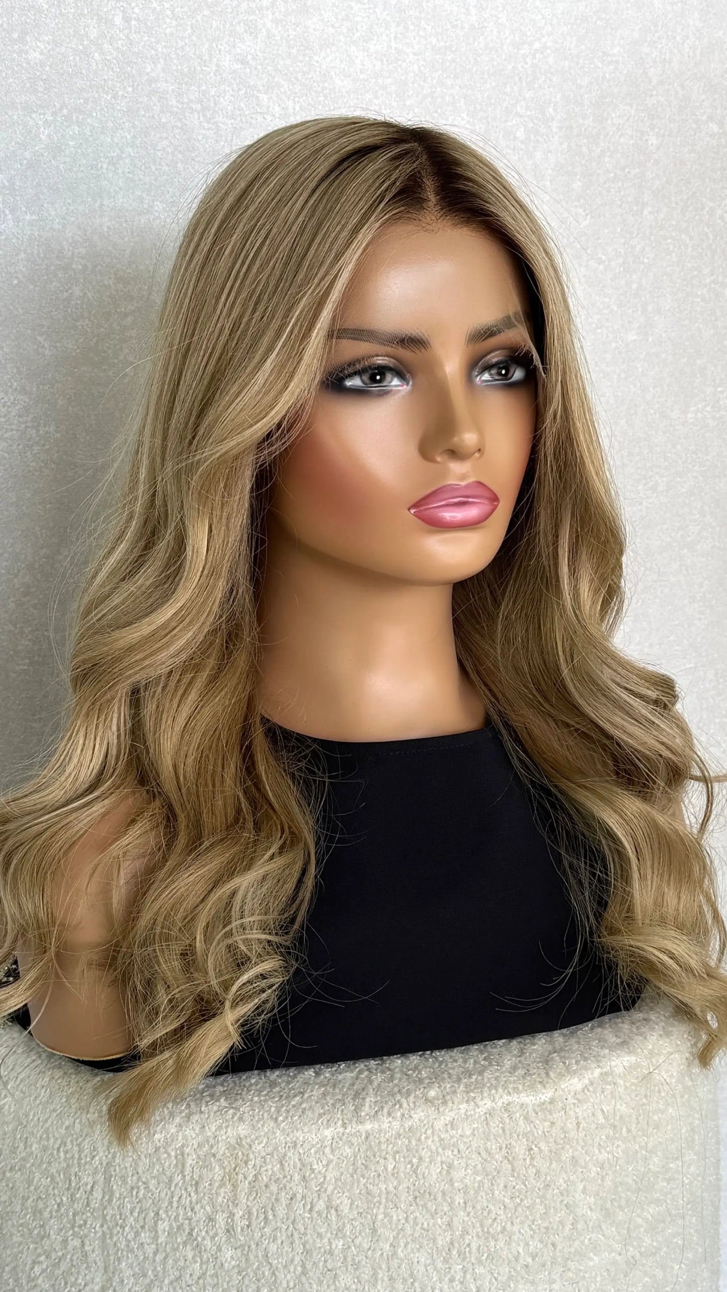 A 22-inch golden blonde wig displayed on a mannequin head, showing lace front detail