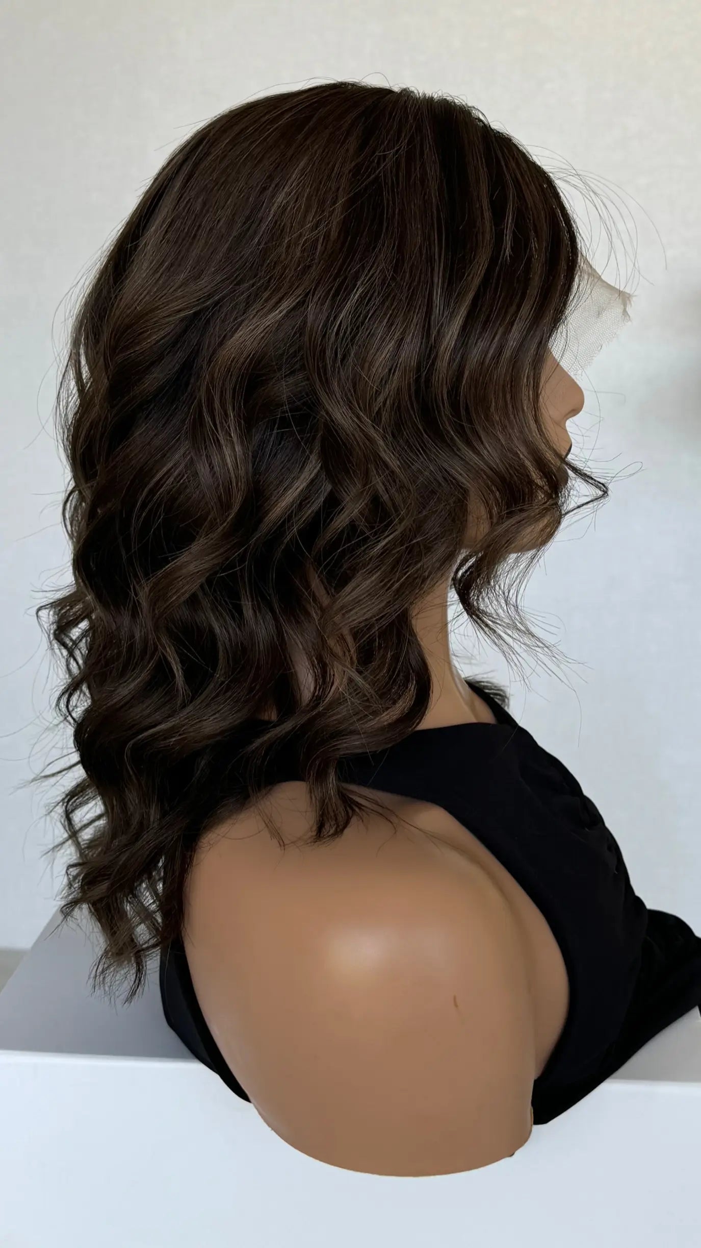 side profile of the Riley wig, highlighting its smooth, glossy texture and refined cool-toned highlights