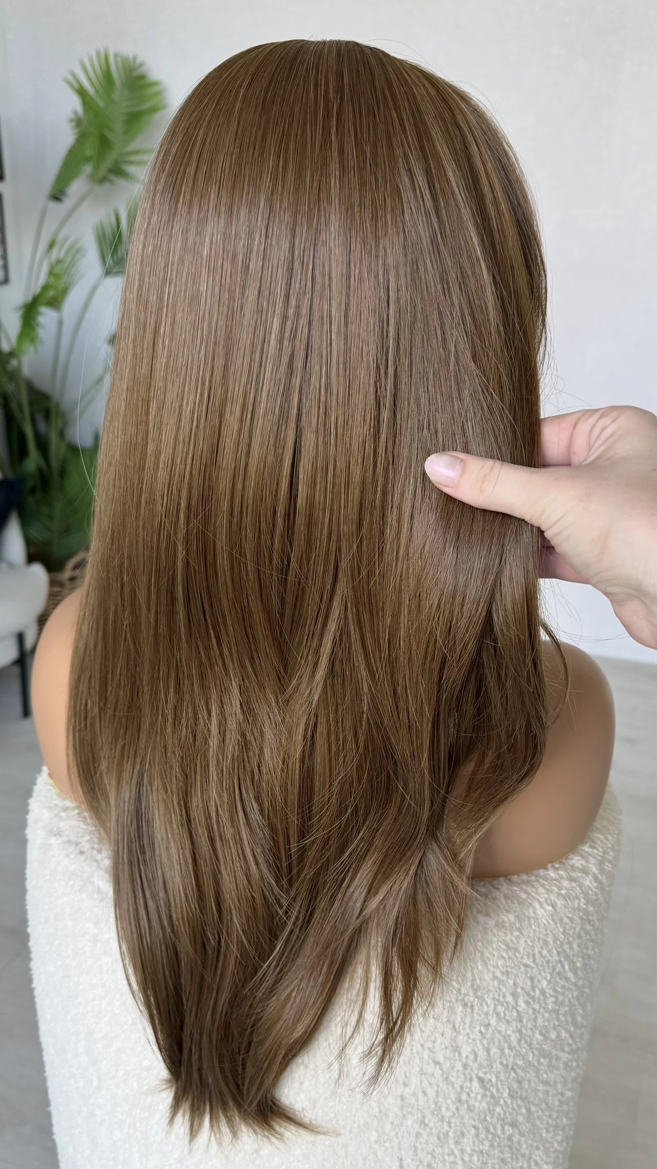 back view, holding the long brunette hair, light layers heat safe wig, with lacefront