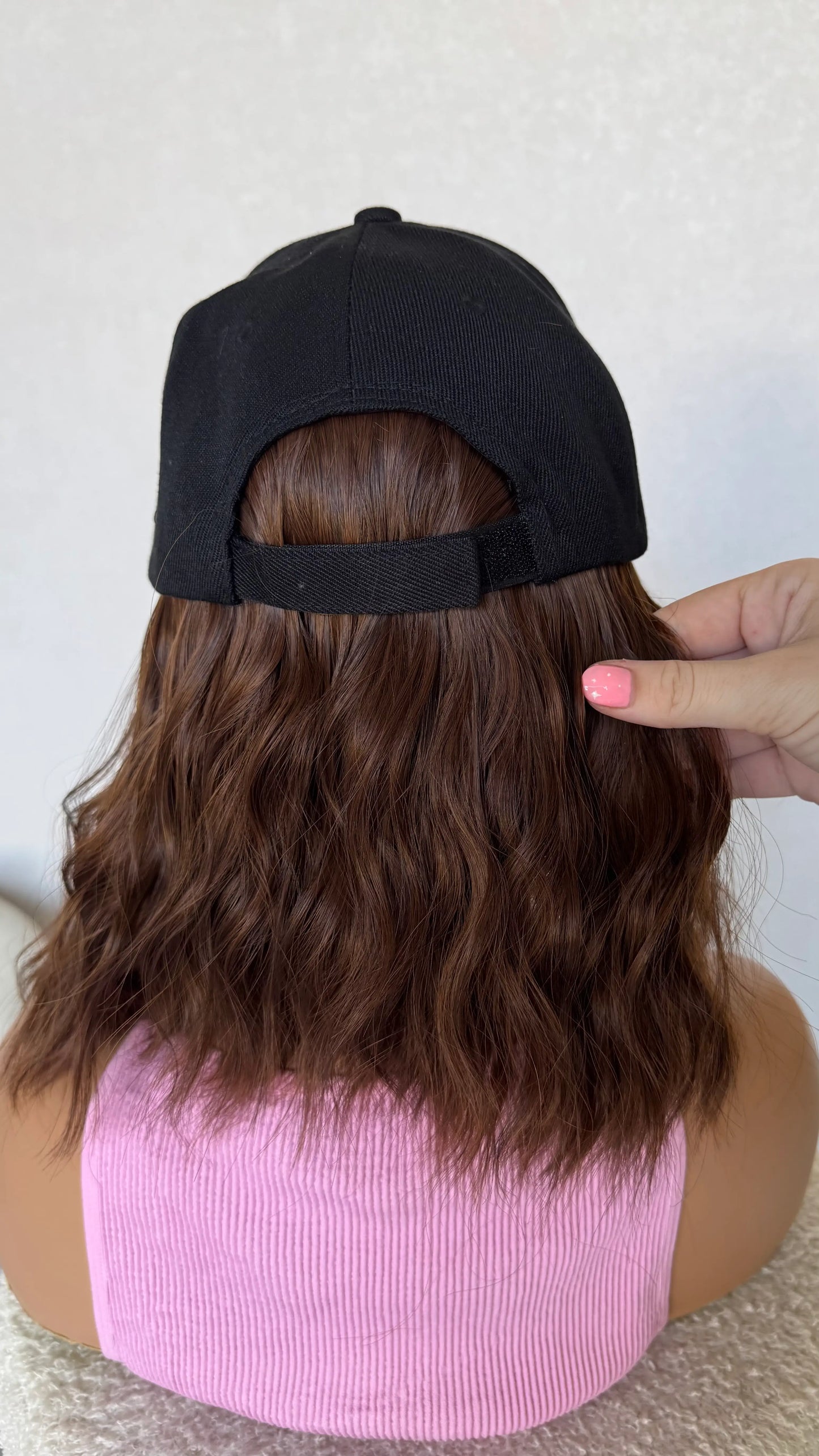 holding hair from behind, 14 inhc wavy brunette, heat safe synthetic, glueless.
