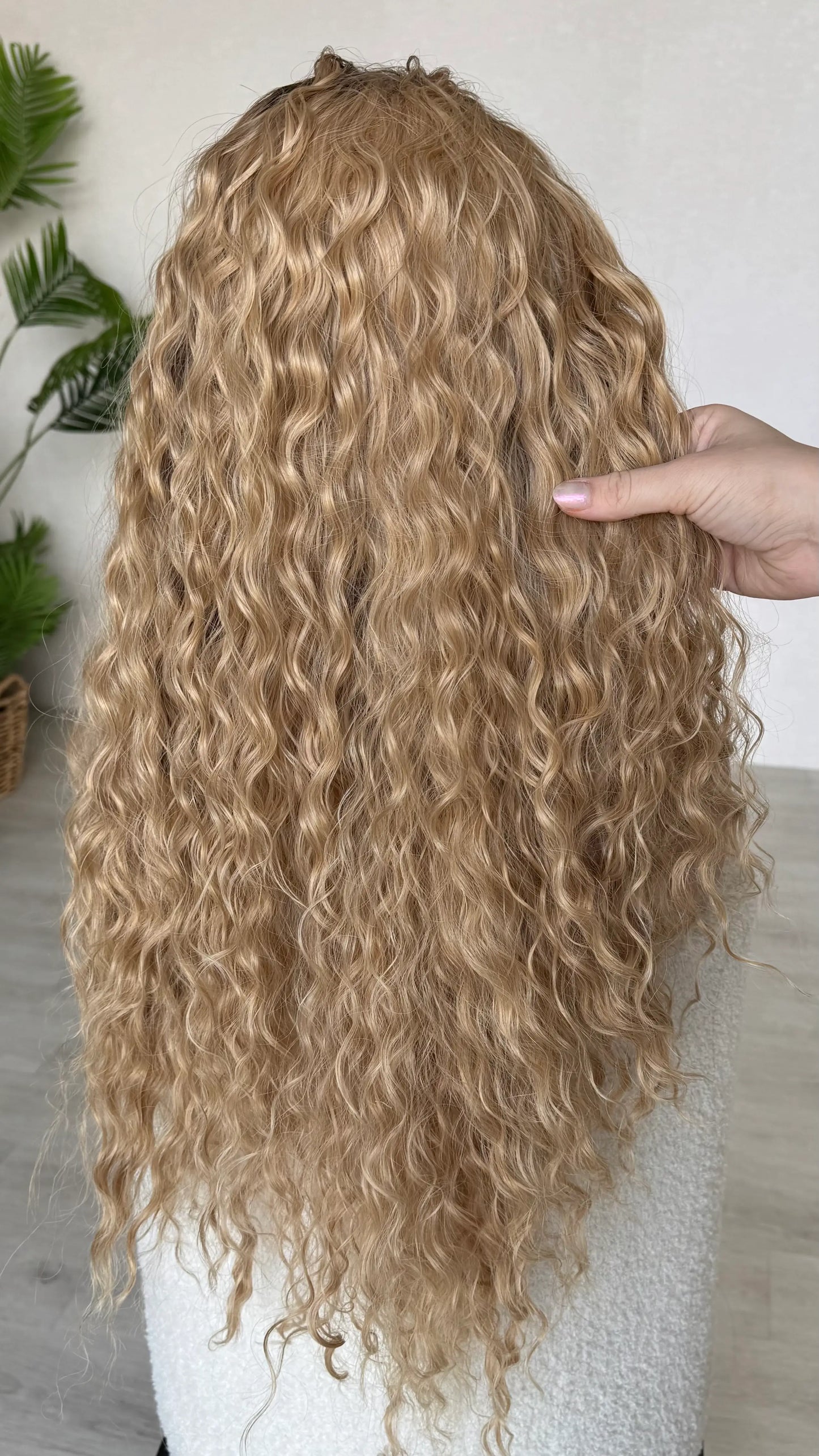 back view holding the long curly hair, 28 inch length.