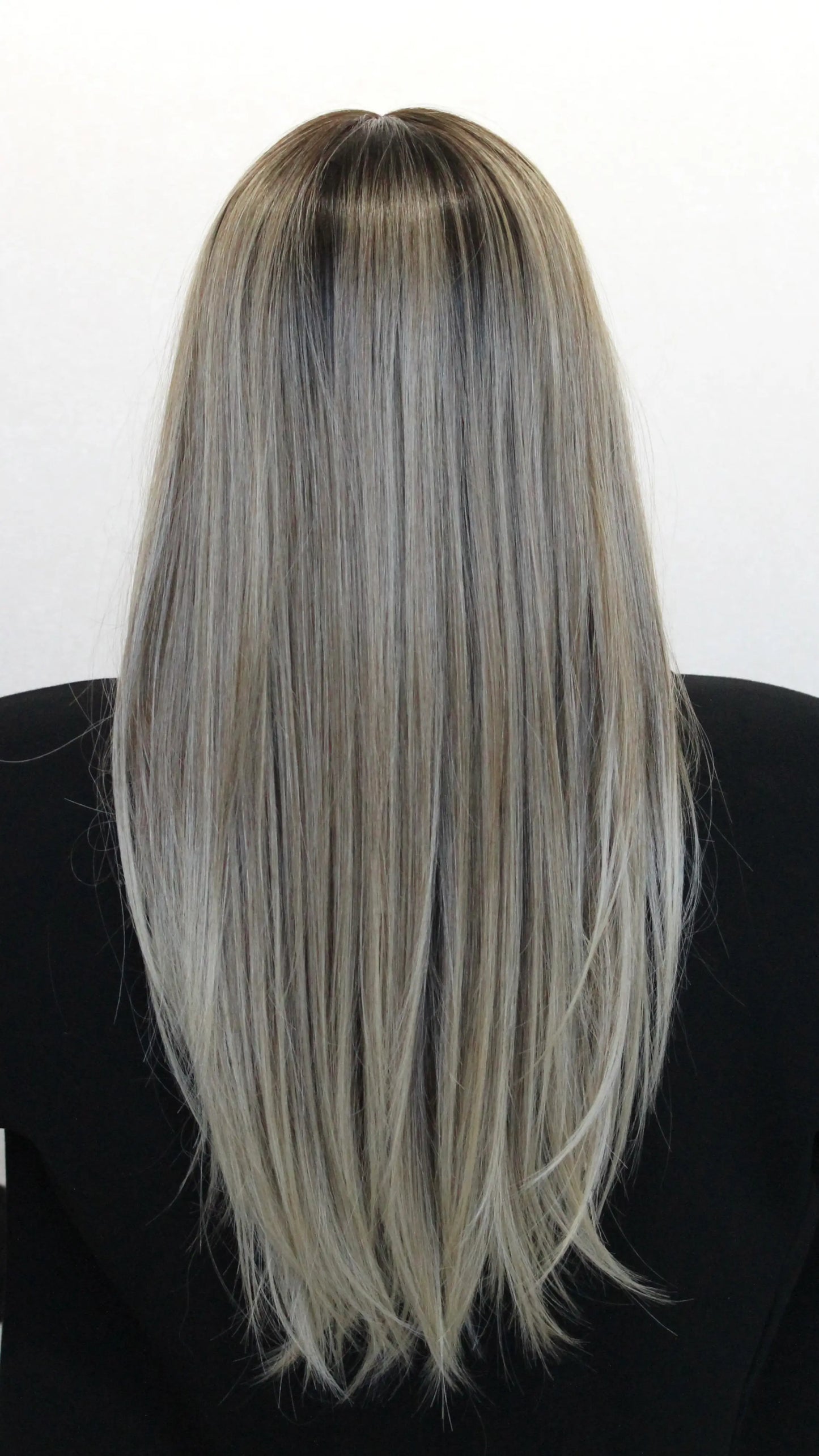back view iconic wig, cool toned blonde with darker root.