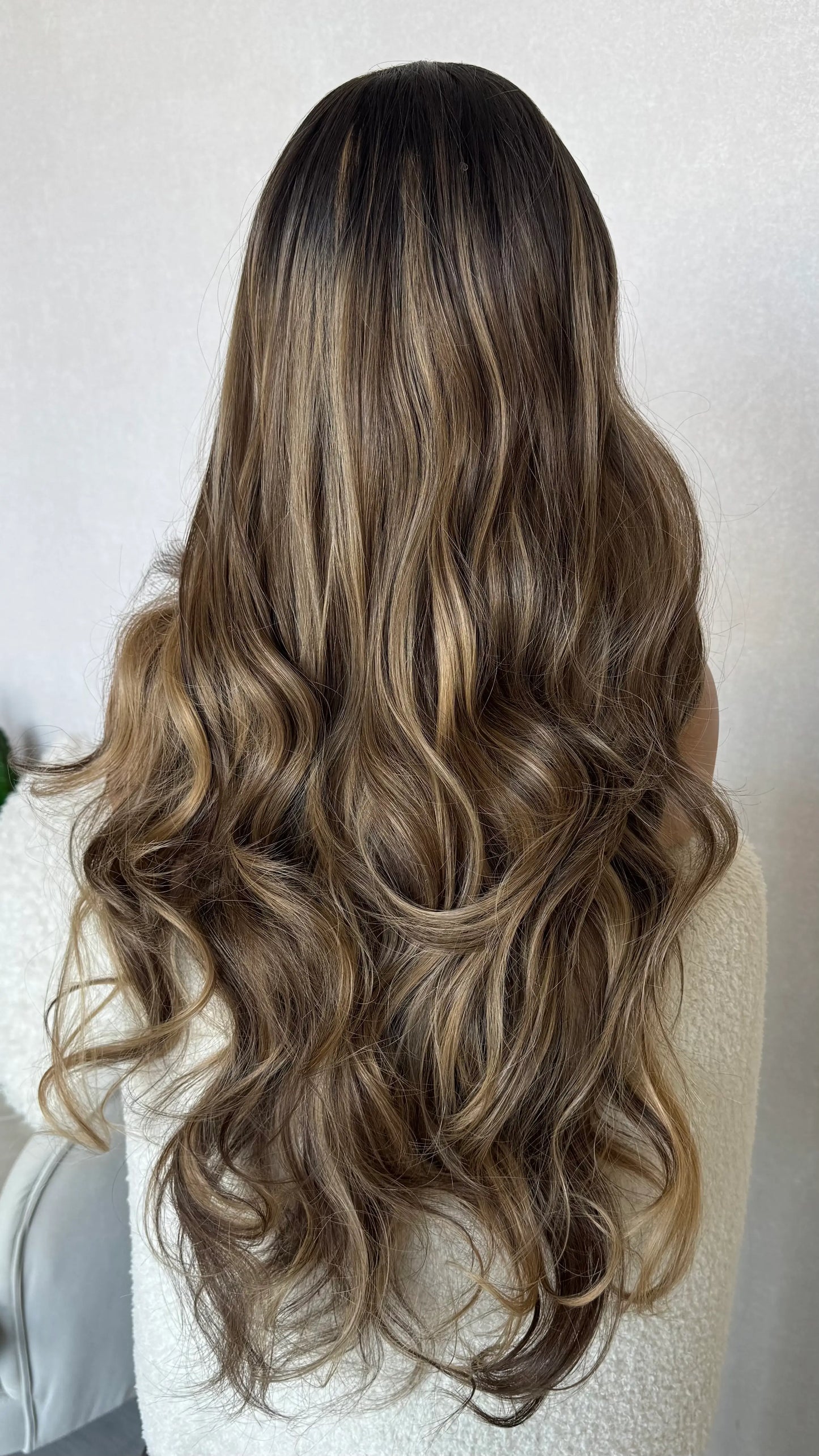 lacefront wig, back view showing long dark brown wavy hair with highlights throughout. australia wigs, lacefronts.