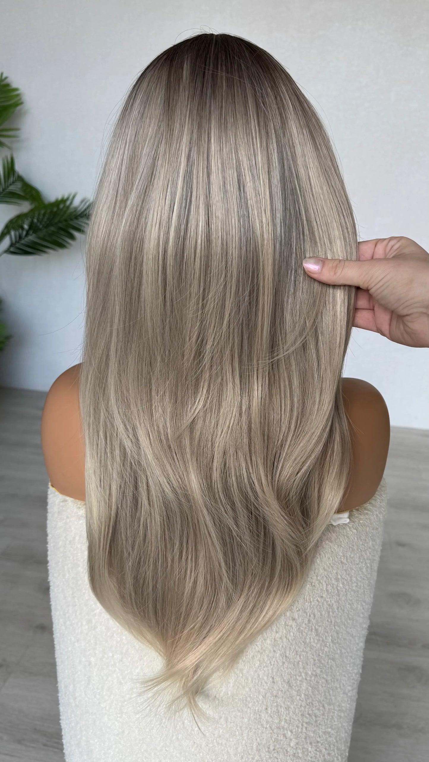 back view natalia holding the ash ombre hair, middle part with curtain bangs.