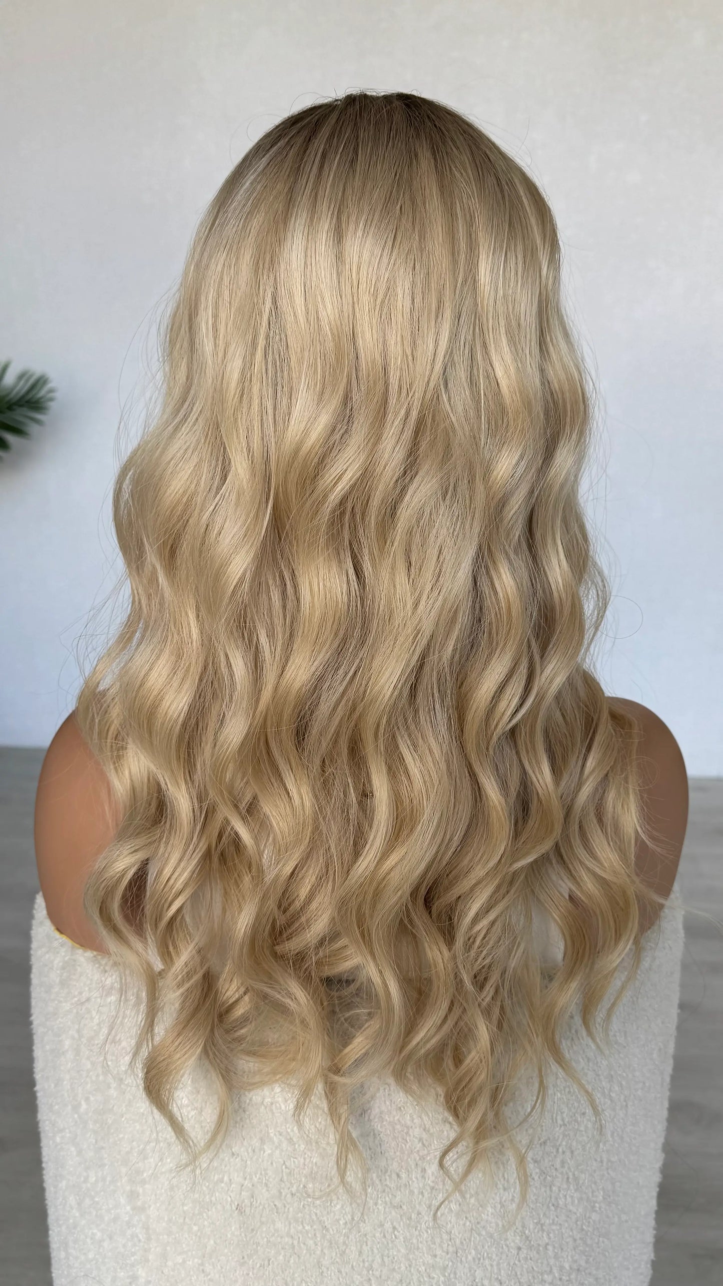 back view 24 inch hair wavy, heat safe synthetic hair, darker root to ombre warm blonde. australia wigs.