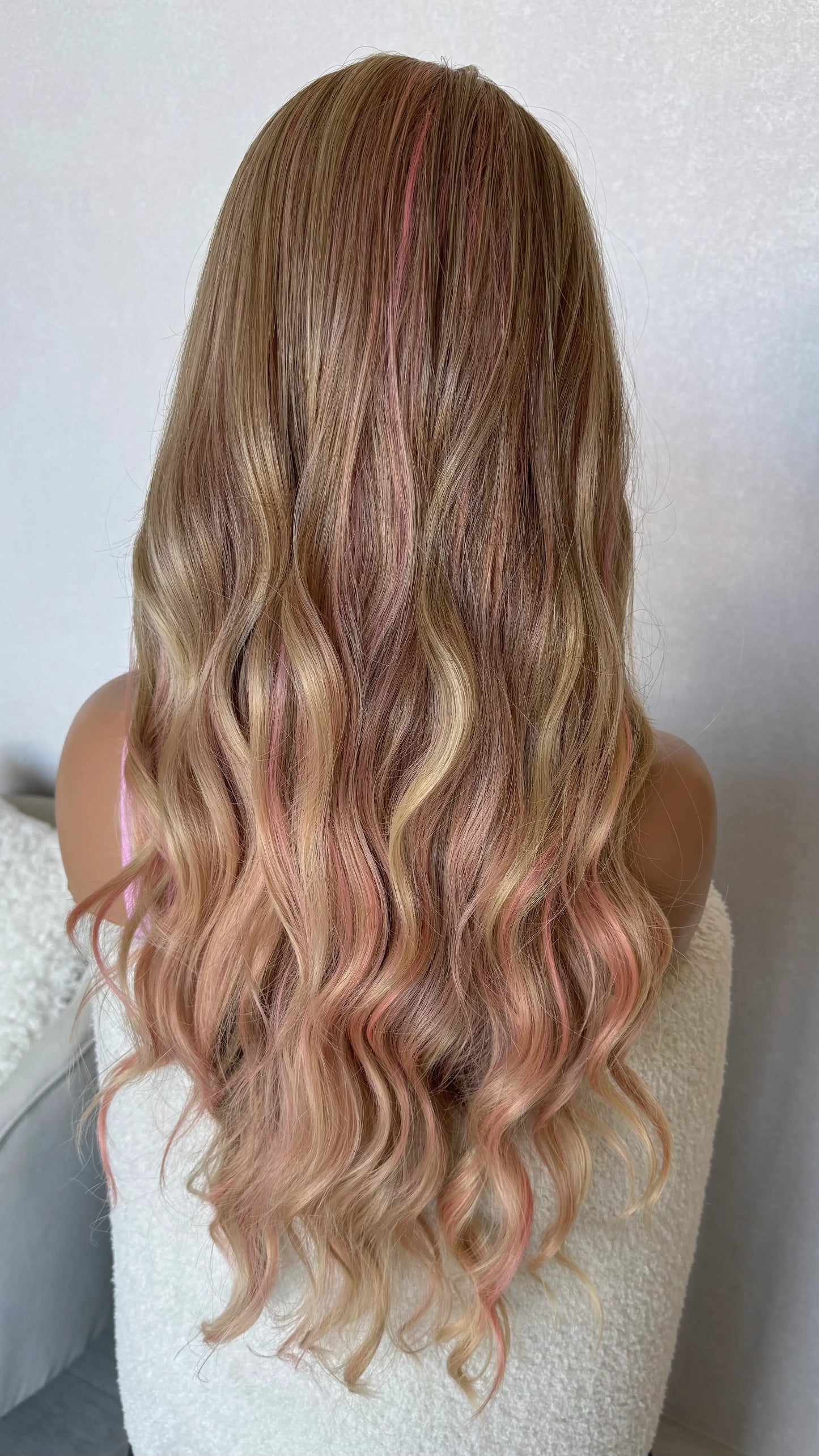 wavy pink and blonde fringe wig, middle part with long hair from back view.