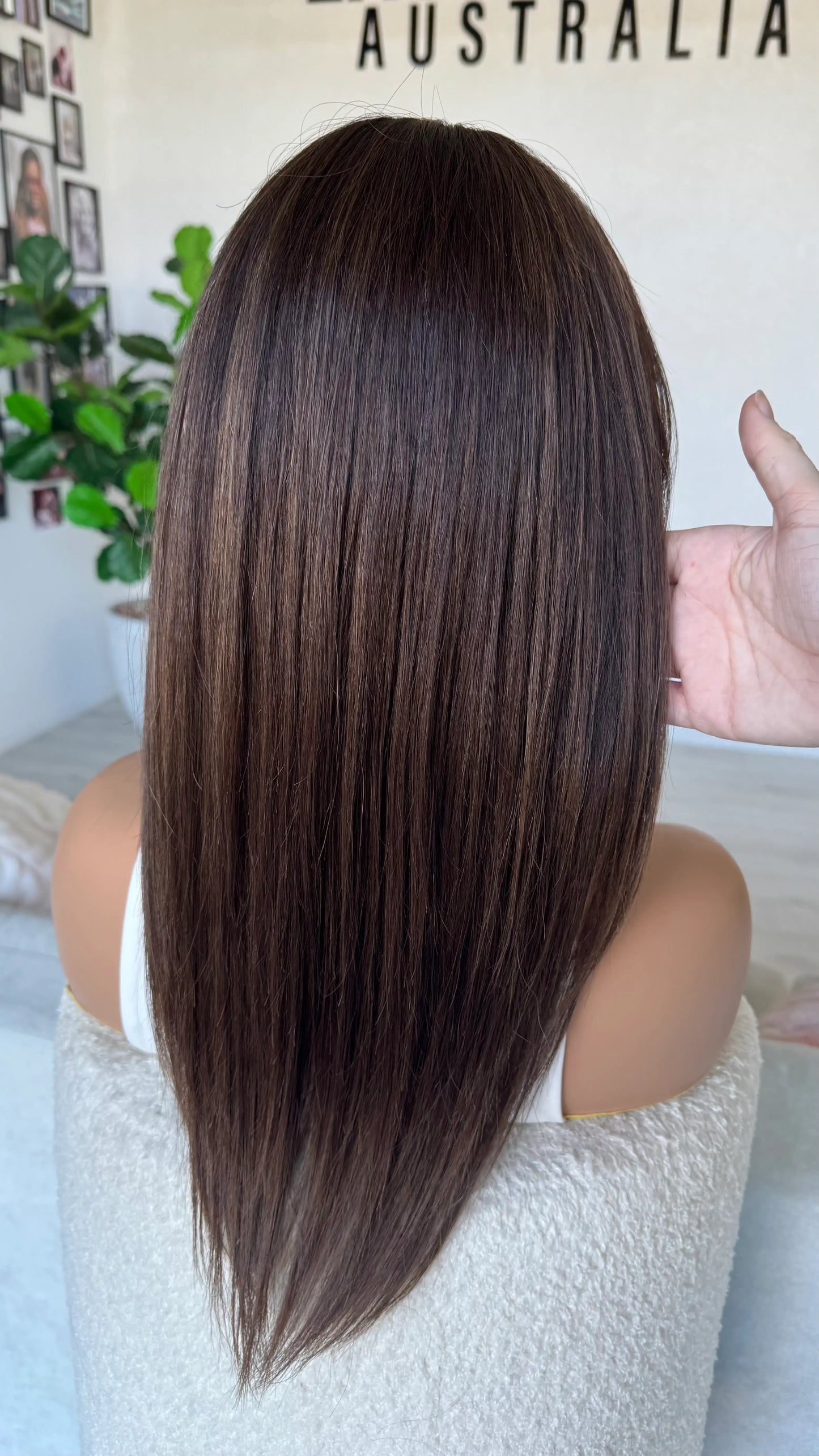 dark brunette wig from back view, holding the silky 22 inch hair, brazilian remy hair, australia.