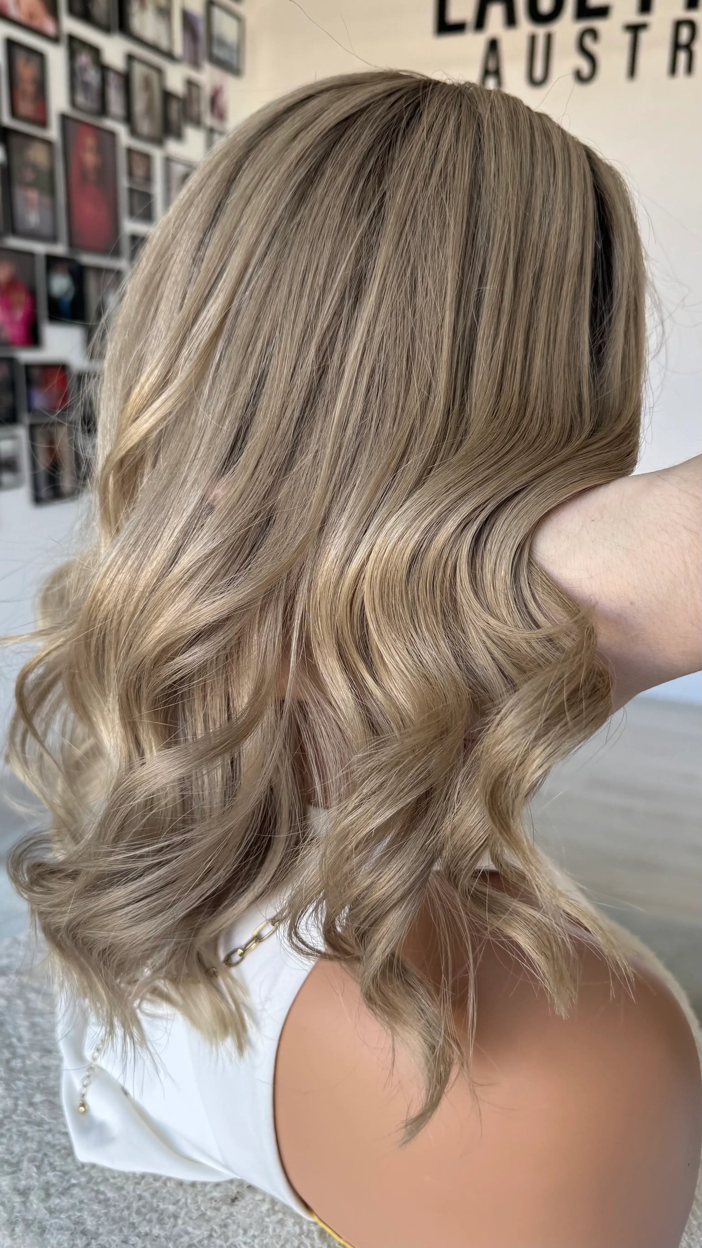 side on view, holding ash blonde hair, brooklyn colour. ash blonde hair, made in australia.