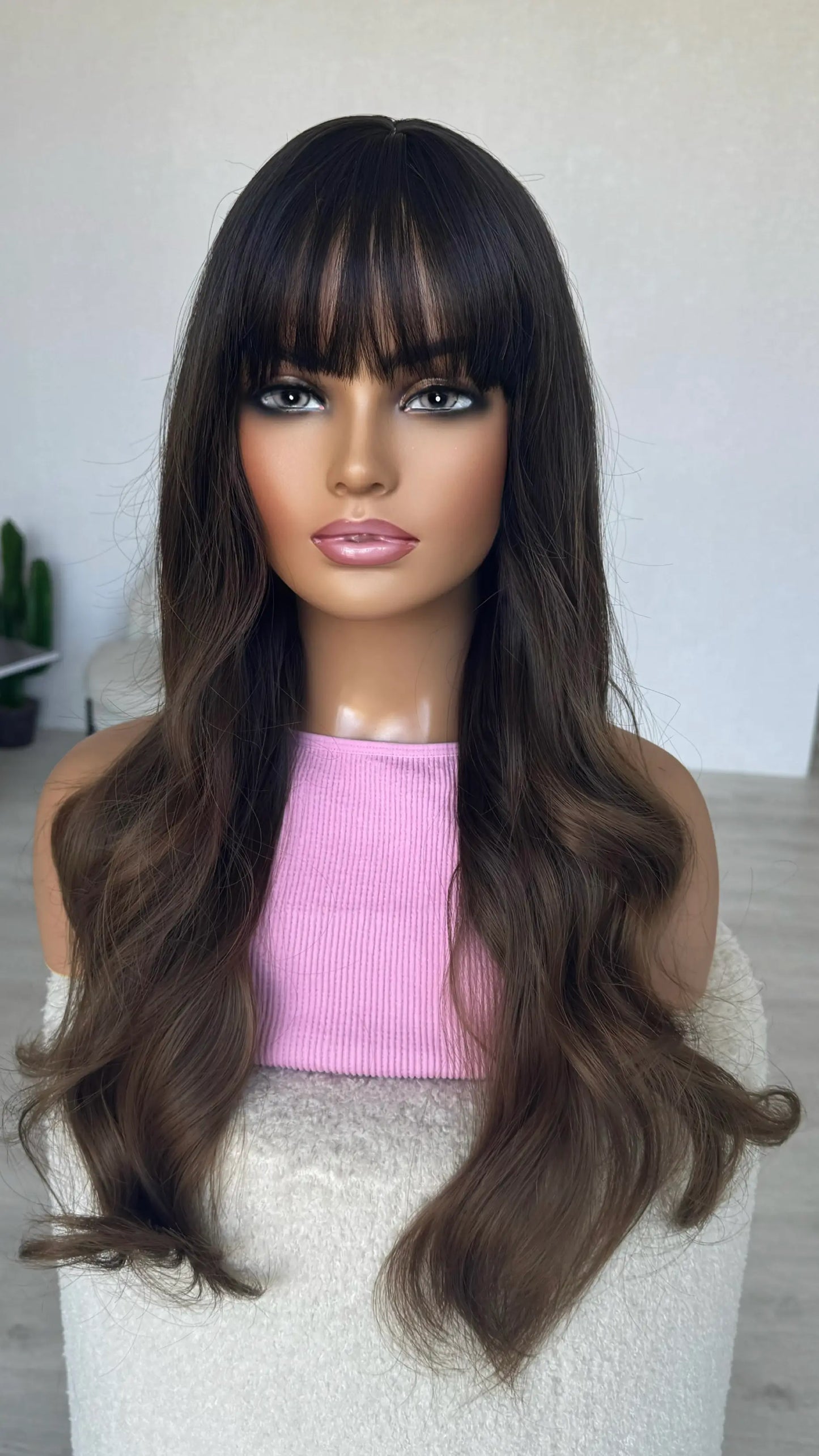 long brunette hair with soft waves. middle part synthetic hair.