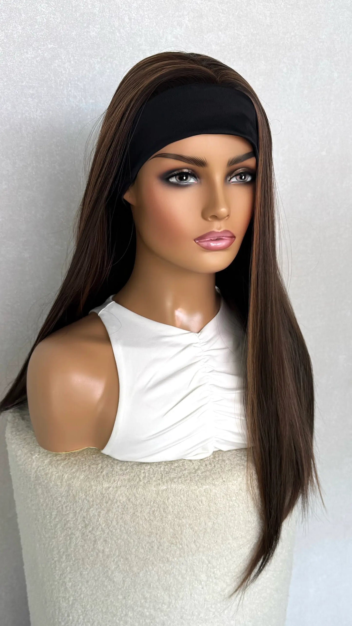 headband wig from side on, with half the hair back. showing headband from the front. heat friendly synthetic wig.