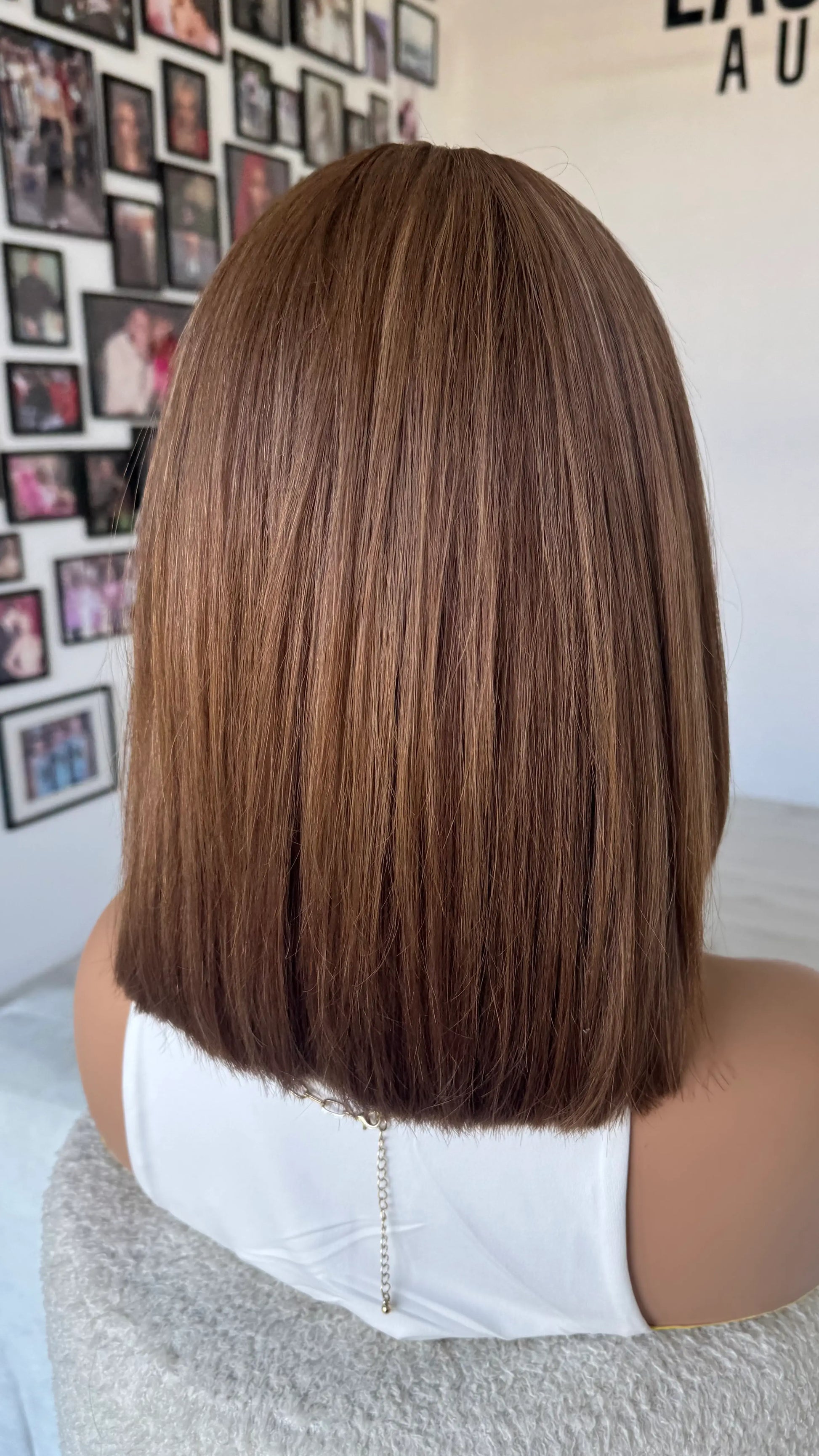 back view of lacefront wig, ella colour, caramel toned brunette, blunt cut 14 inch length. straight hair wig.