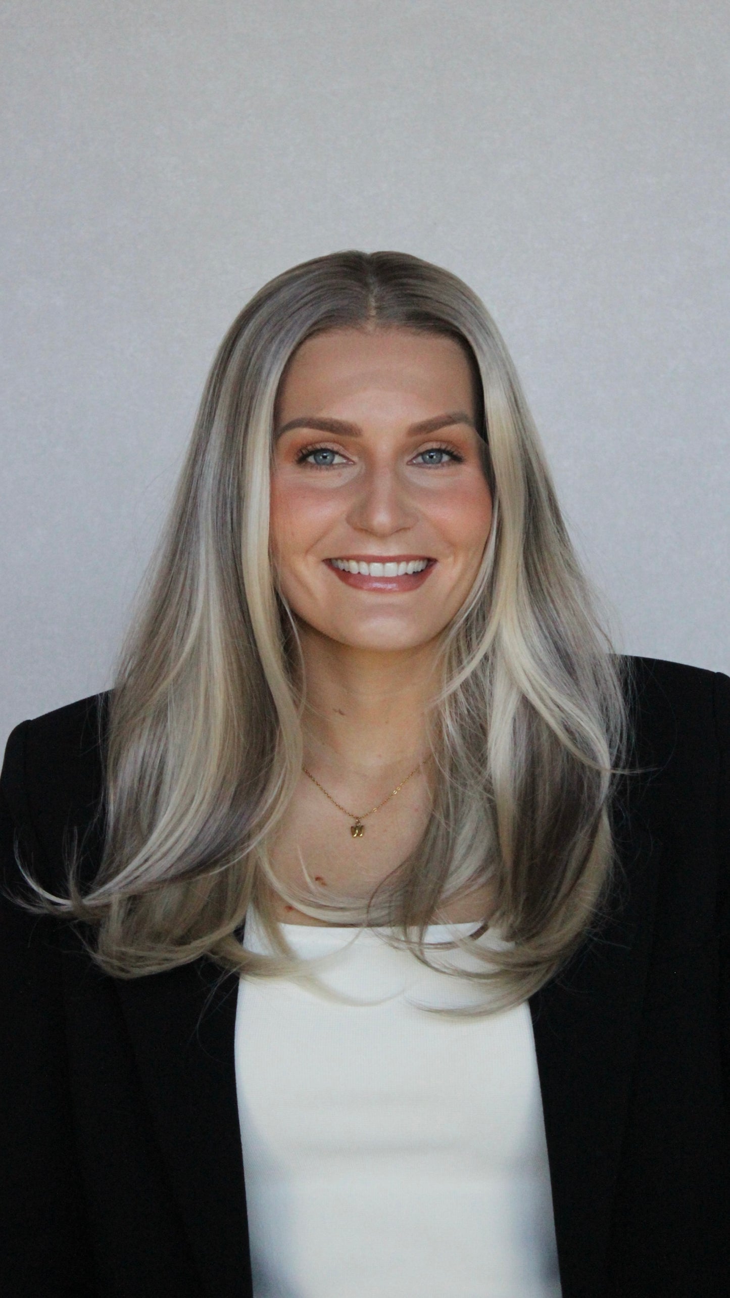 christina synthetic front on view, darker root to lowlighted blonde, layered synthetic hair, wigs australia.