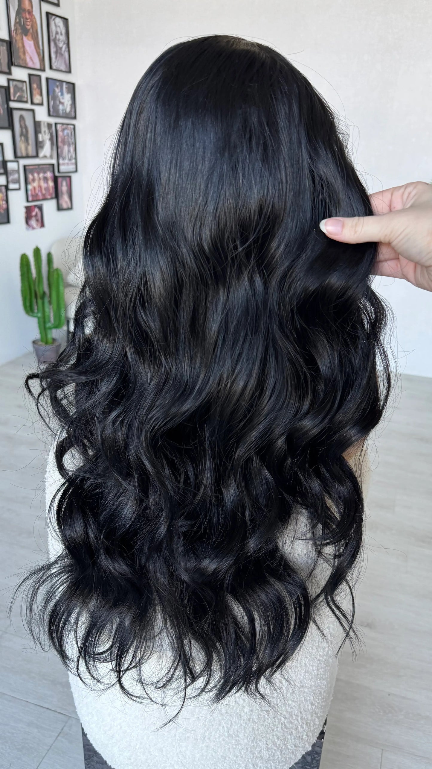 holding hair from back view, long wavy black hair