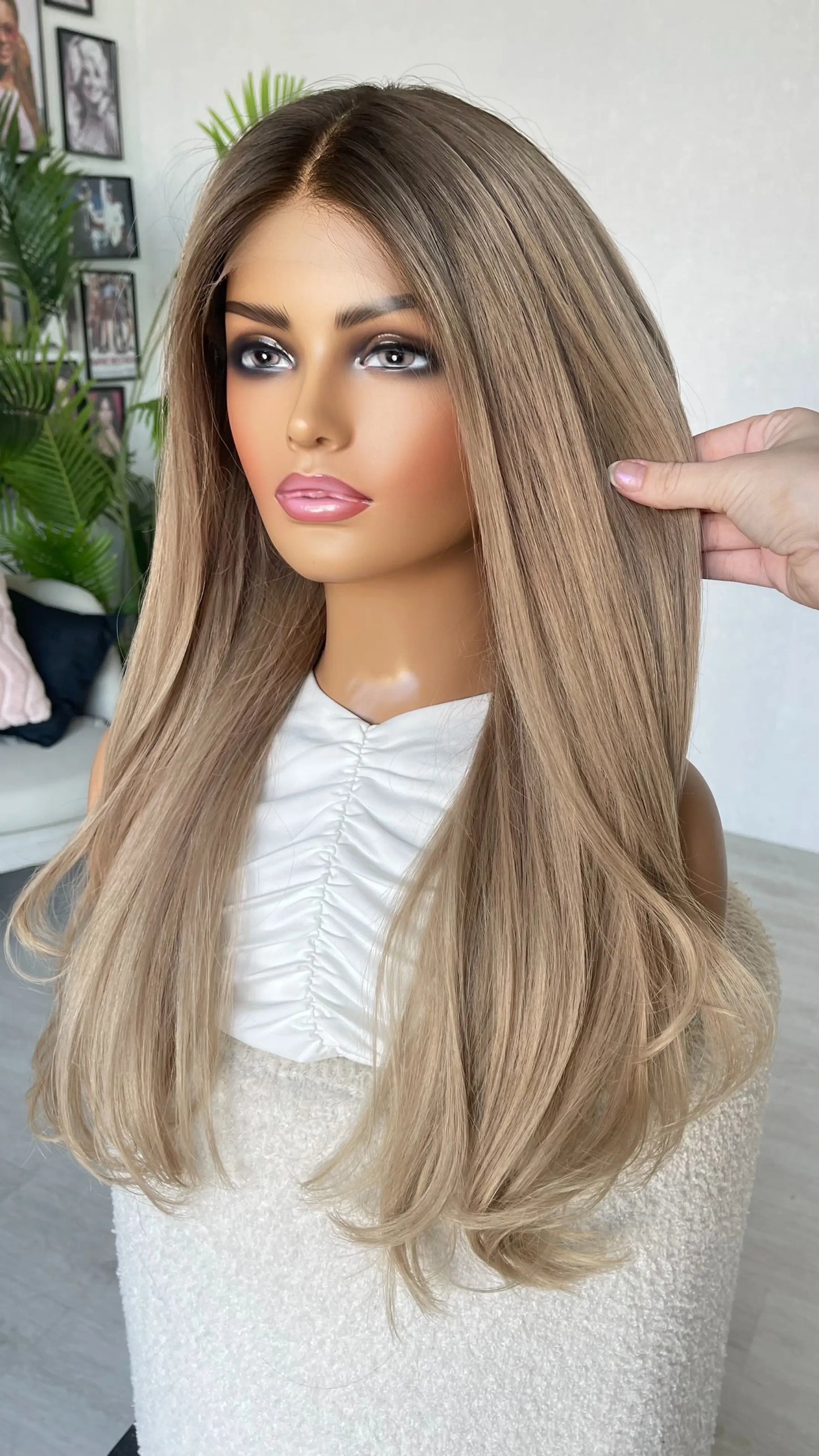 lacefront brazilian remy hair, holding the long ash blonde hair, darker root middle part.