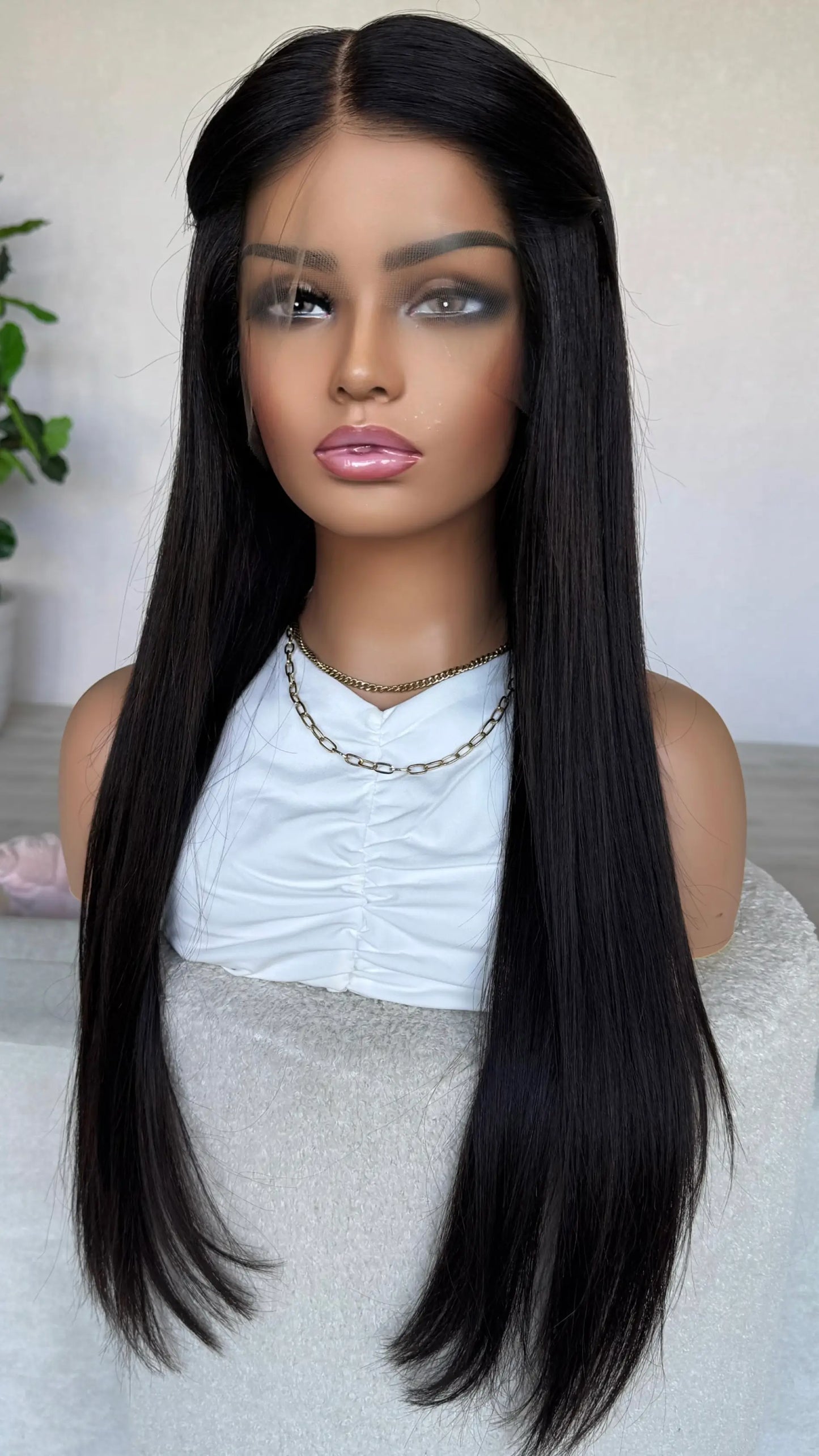 black hair wig with hair pinned back. middle part, straight hair. brazilian remy hair.