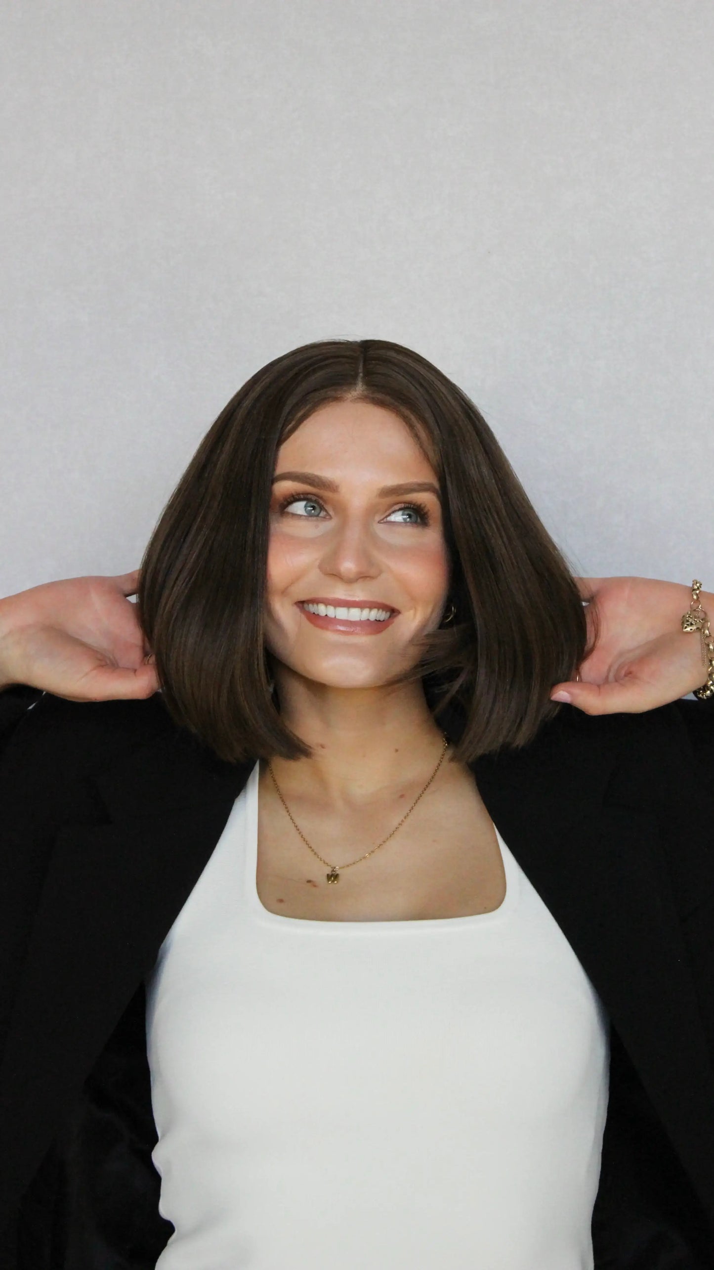 synthetic heat safe brunette bob, lacefront 12 inch length. middle part with baby hairs.