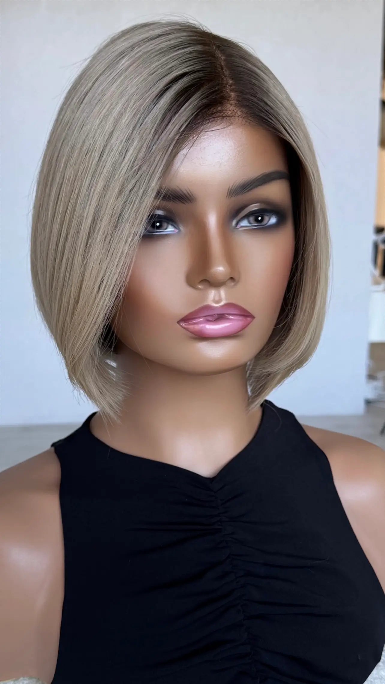 blonde with shadow root wig, side on, showing natural part and colour.