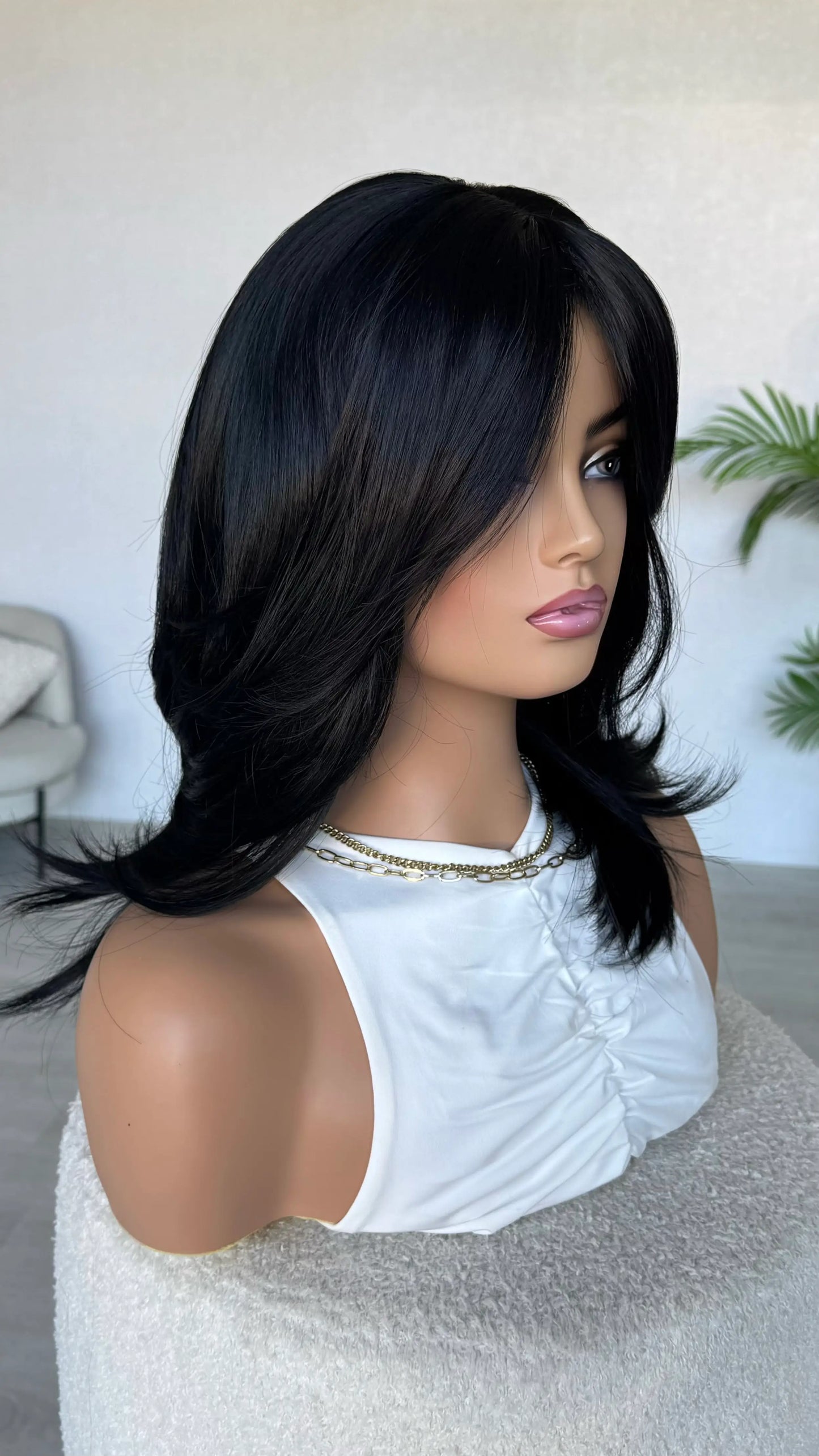 gluelss wig from side view, long layers in blue black hair.