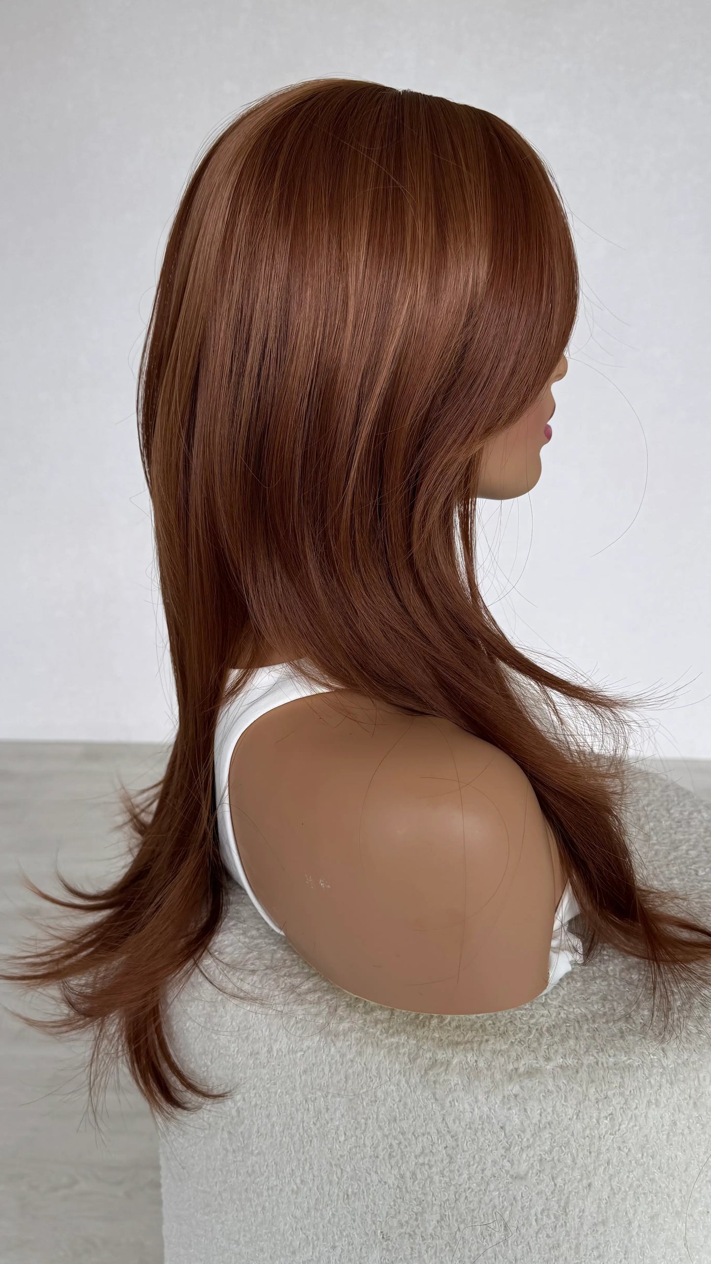 layered ginger hair side on view, long length hair.