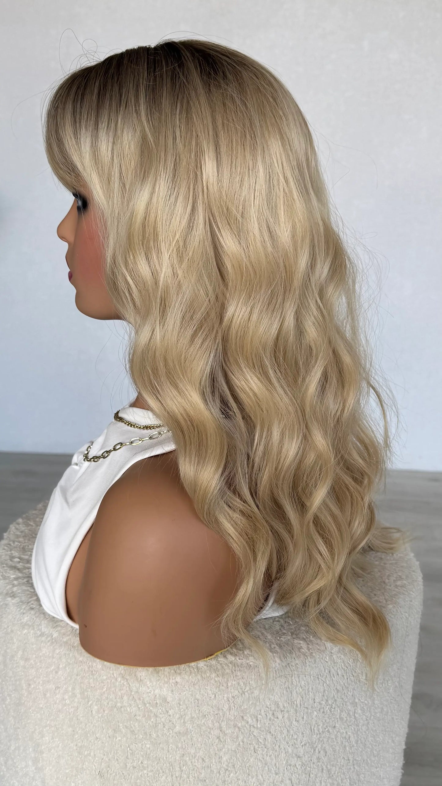 dark root to long blonde ombre, middle part with fringe and waves. long hair.