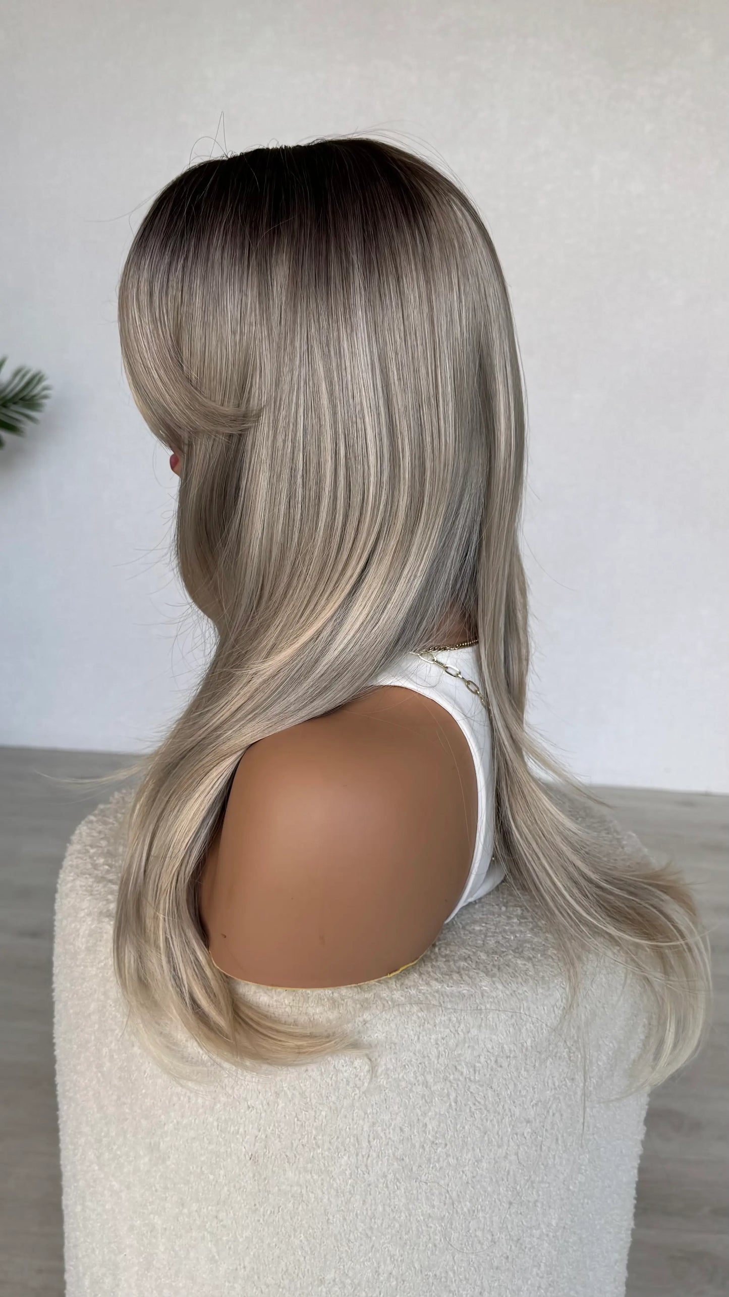side view, darker root with ash blonde ombre.