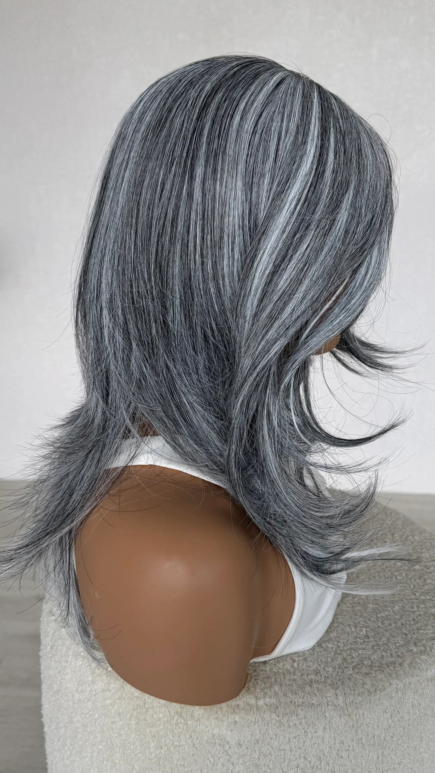 side view salt and pepper wig, layered long hair.