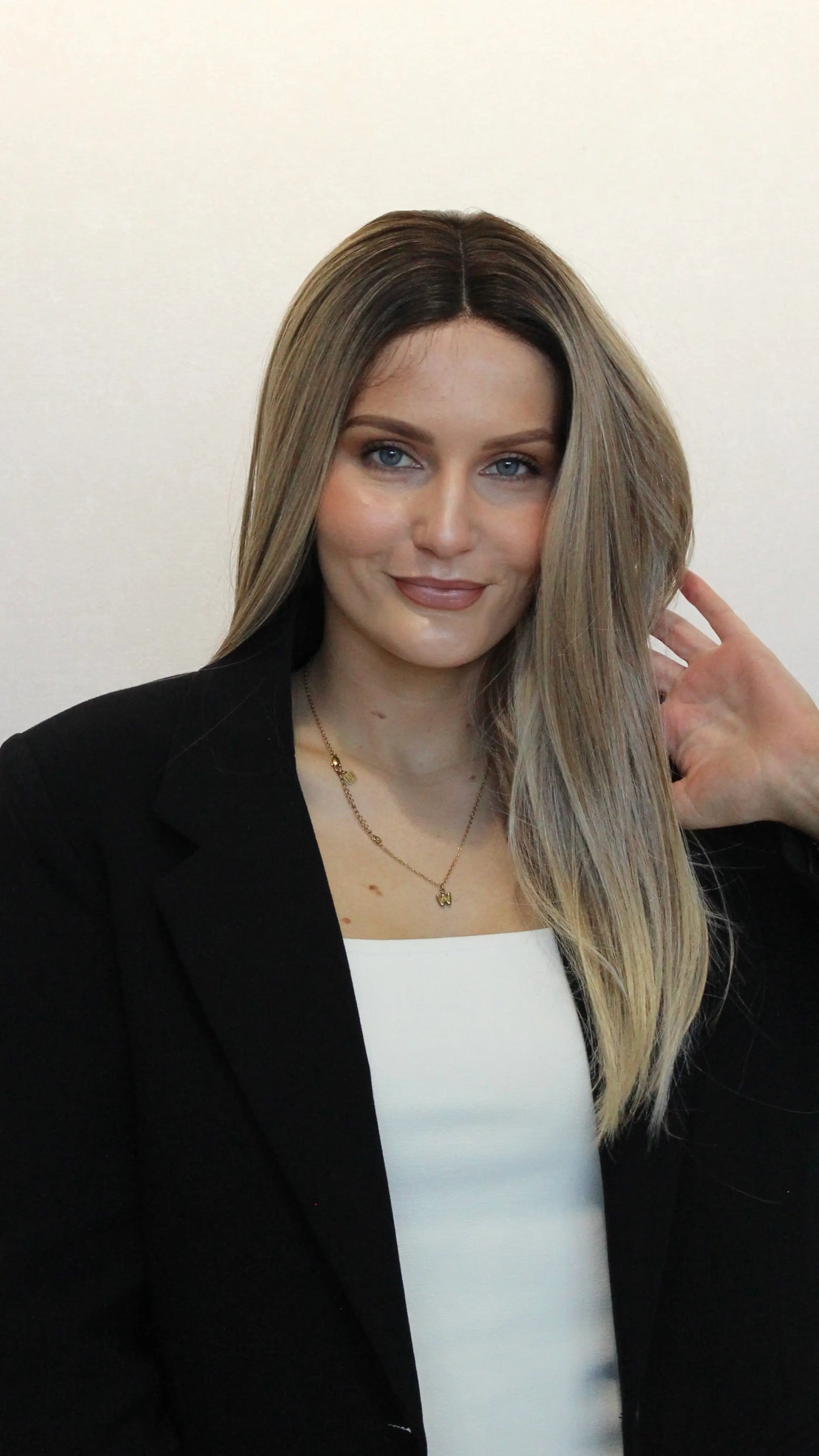 straight lacefront wig iconic, darker root, middle part.