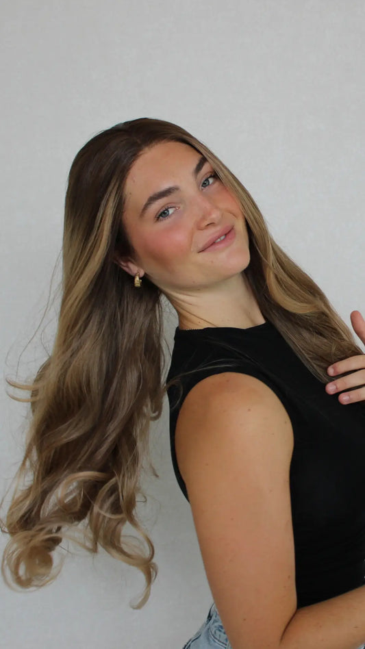 Studio lighting highlights the soft, tangle-free fibres of this premium synthetic lace front wig