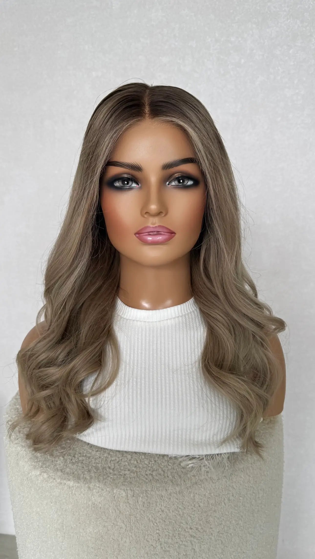 lace front wig, ash blonde, darker root with face framing highlight.