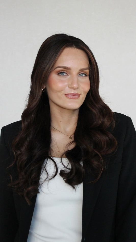 26 inch curled dark brown hair middle part with face framing highlights.