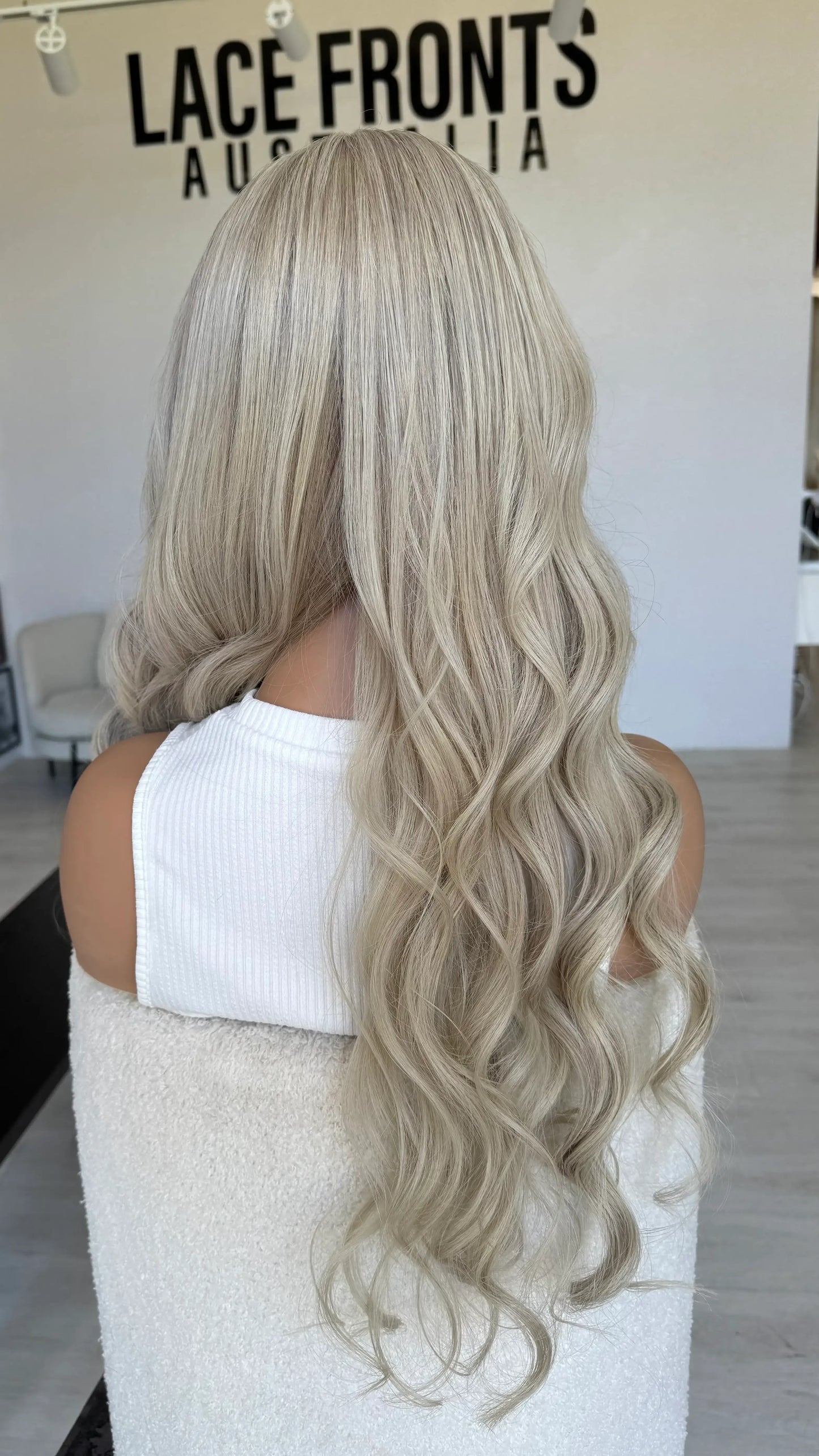 26 inch long blonde hair lace front wig australia, curled hair, back view, half hair forward.