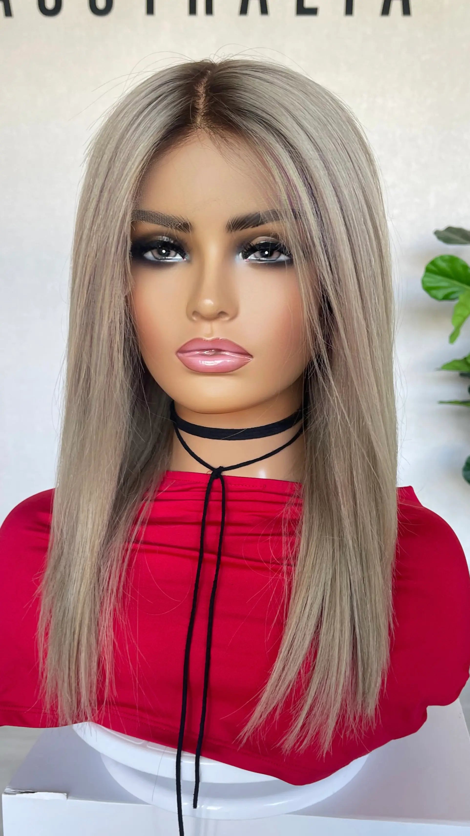 An 18-inch ash blonde lace front wig with a soft shadow root, offering a natural gradient and seamless blend