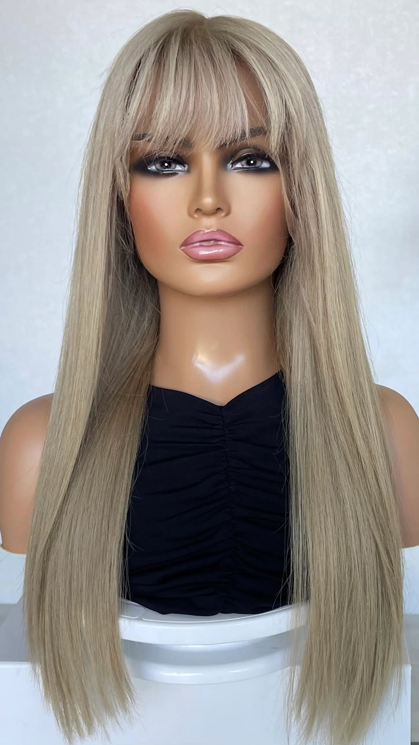 A 24-inch human hair lace front wig in Clean Pearly Ash Blonde, featuring a silky smooth finish and natural movement