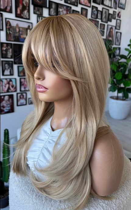 side on view, layered gold blonde hair with darker root, heat safe