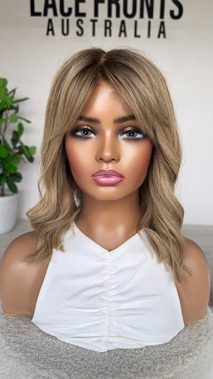 front view, fringe parted to the side, blonde wig with fringe.