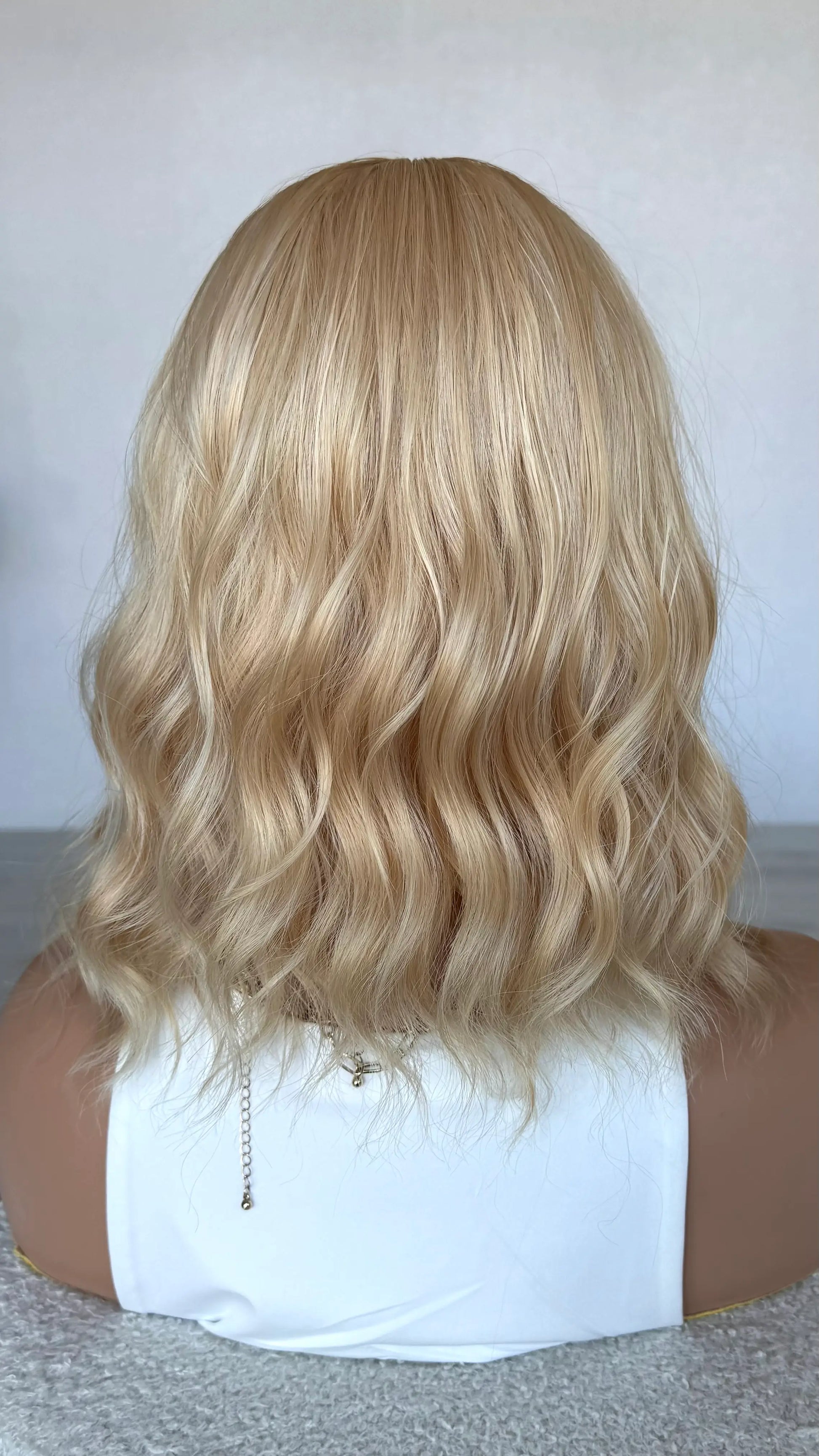 honey wig from the back view, wavy blonde hair wig. australia.