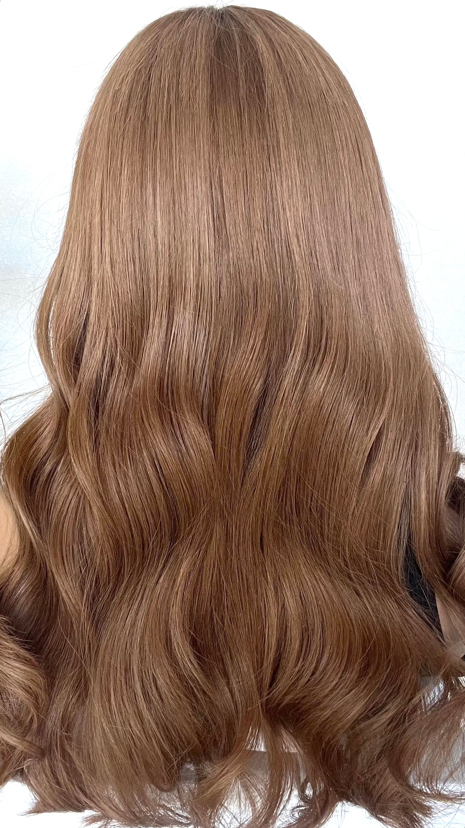 back view of the JESSICA wig, showcasing its vibrant dark copper blonde shade with soft, flowing layers for added volume