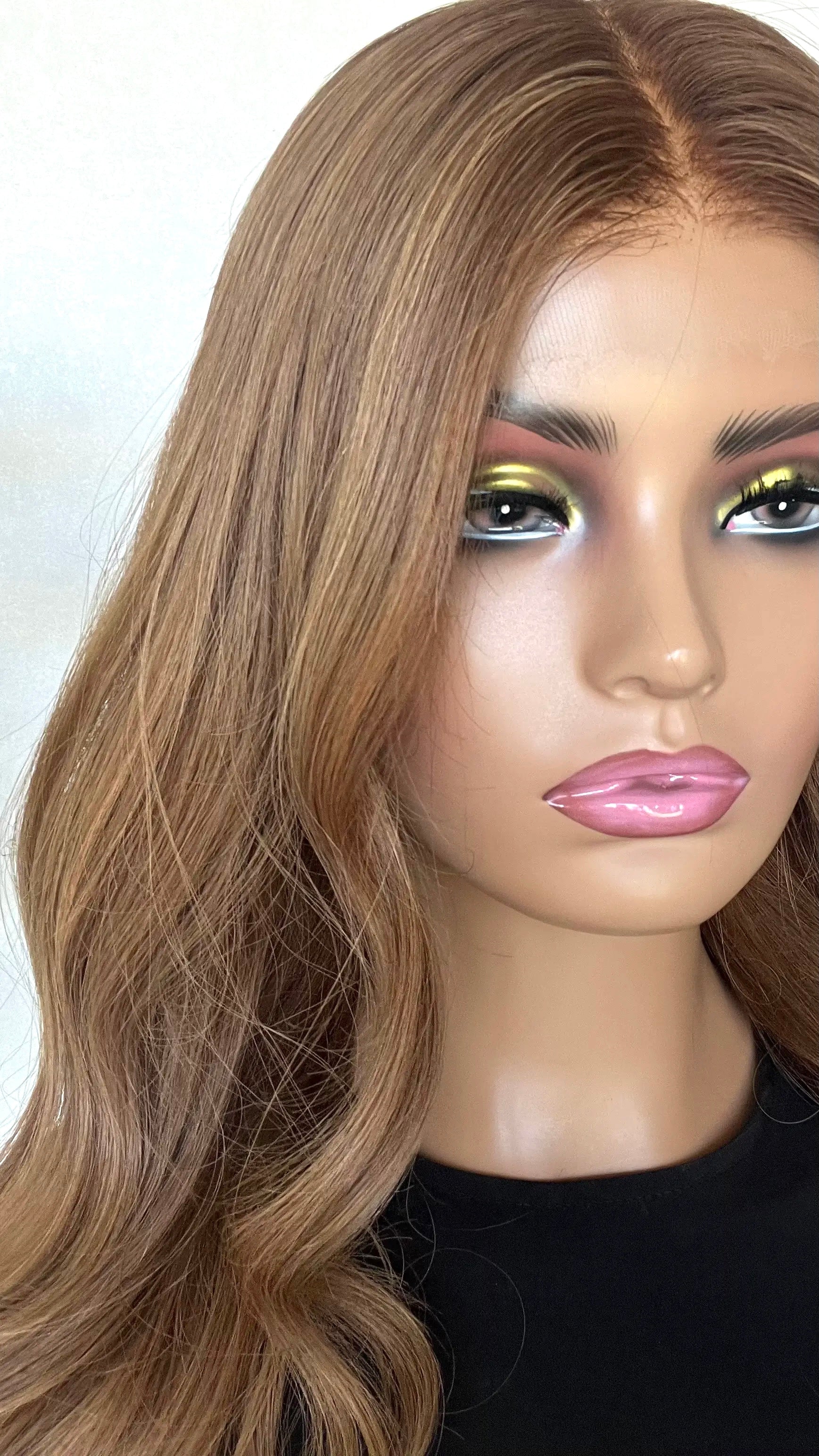 A close-up of the JESSICA wig, highlighting its deep copper blonde hue, silky texture, and seamless lace front