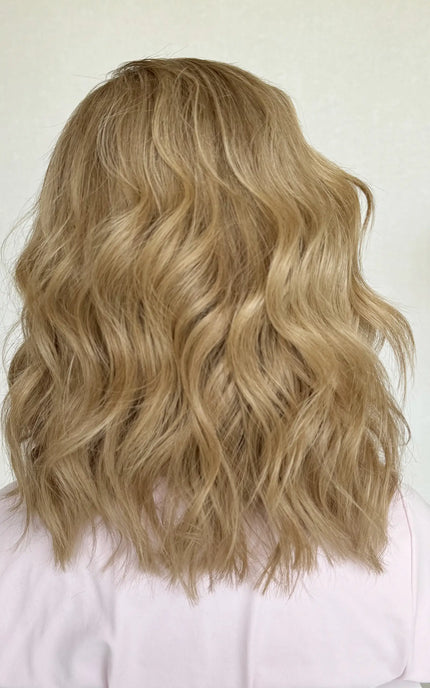 Back shot of the JUDY wig, showcasing its warm blonde base with subtle highlights and a seamless lace front for a natural loo