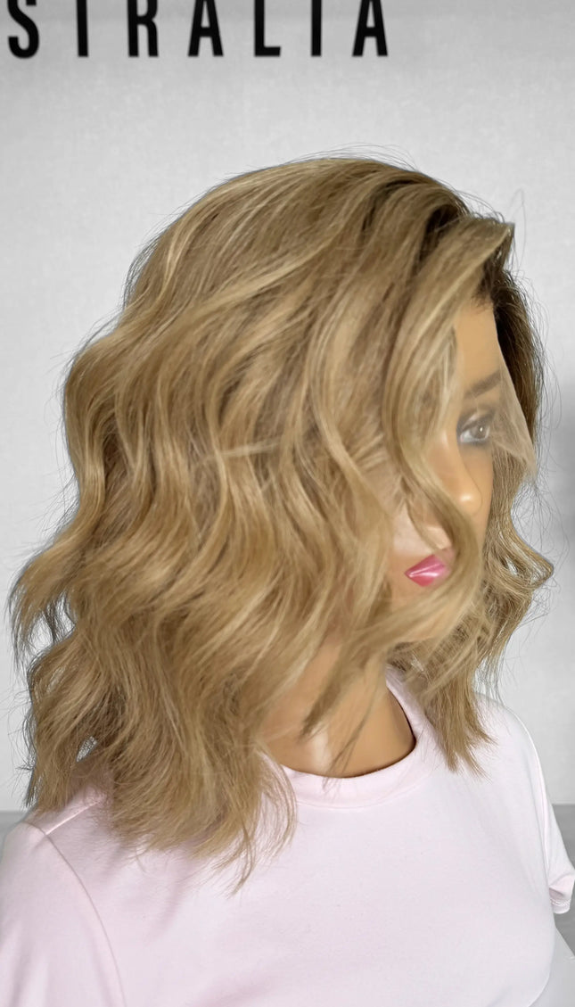 Another side view of the JUDY wig, featuring warm blonde tones with delicate highlights